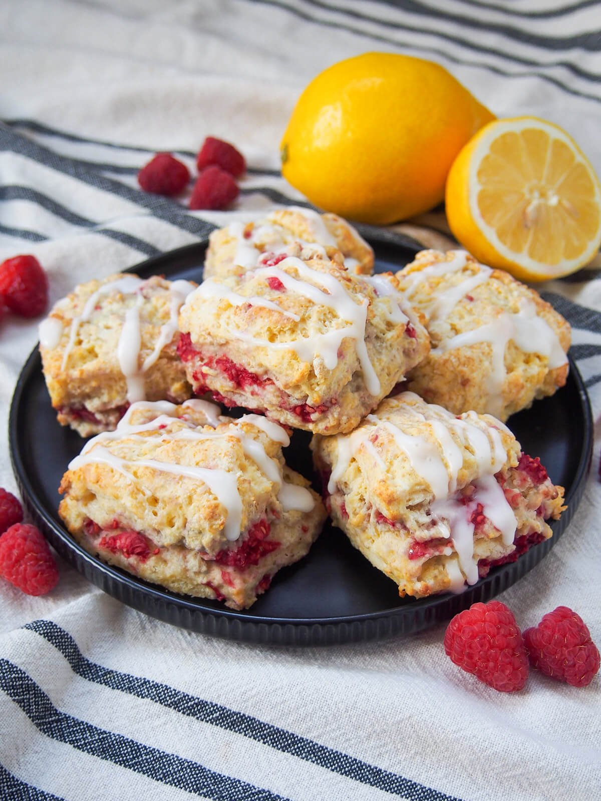 plate of small sized raspberry scones with lemon glaze