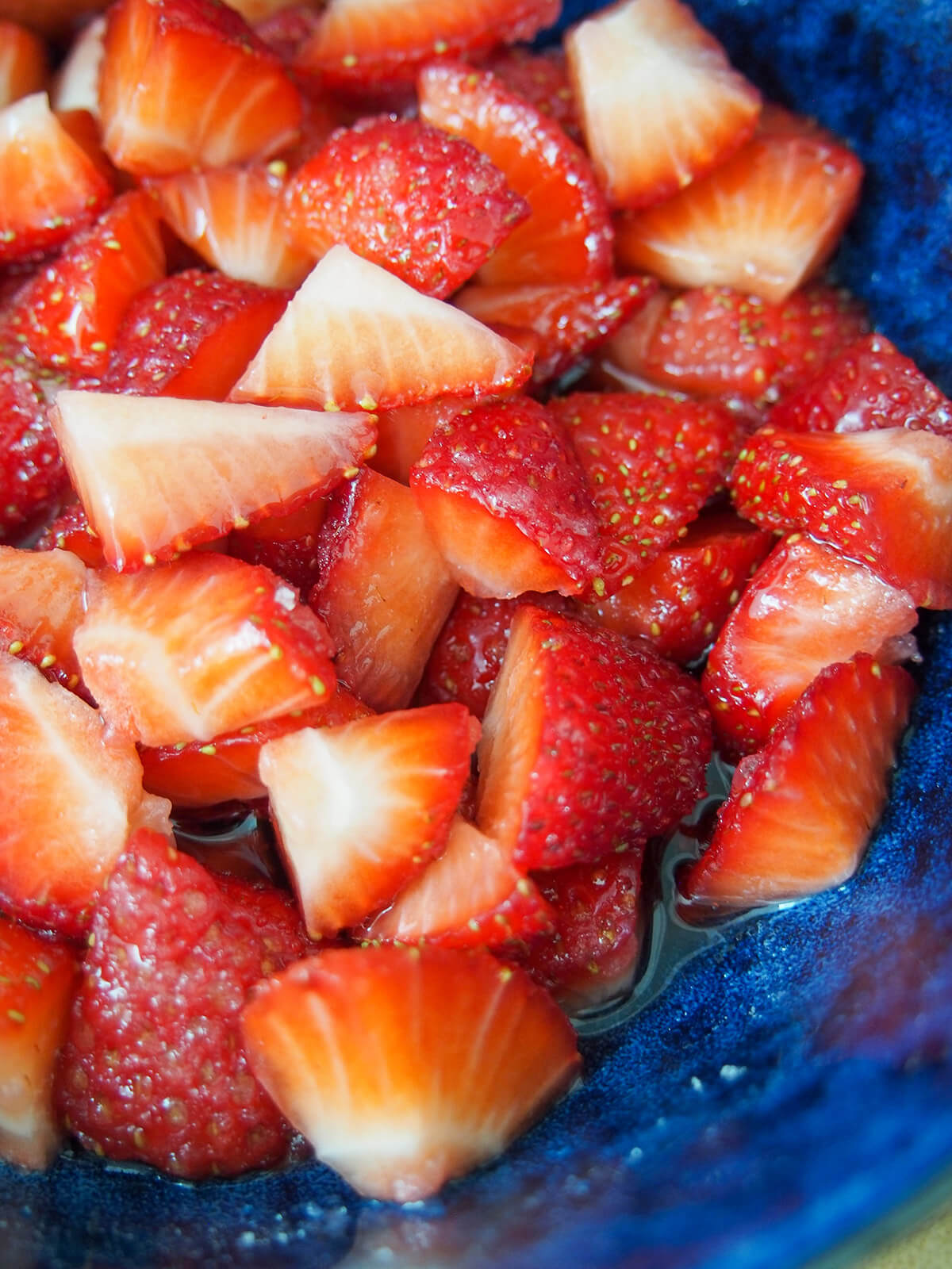 macerated strawberries in bowl with juices at bottom