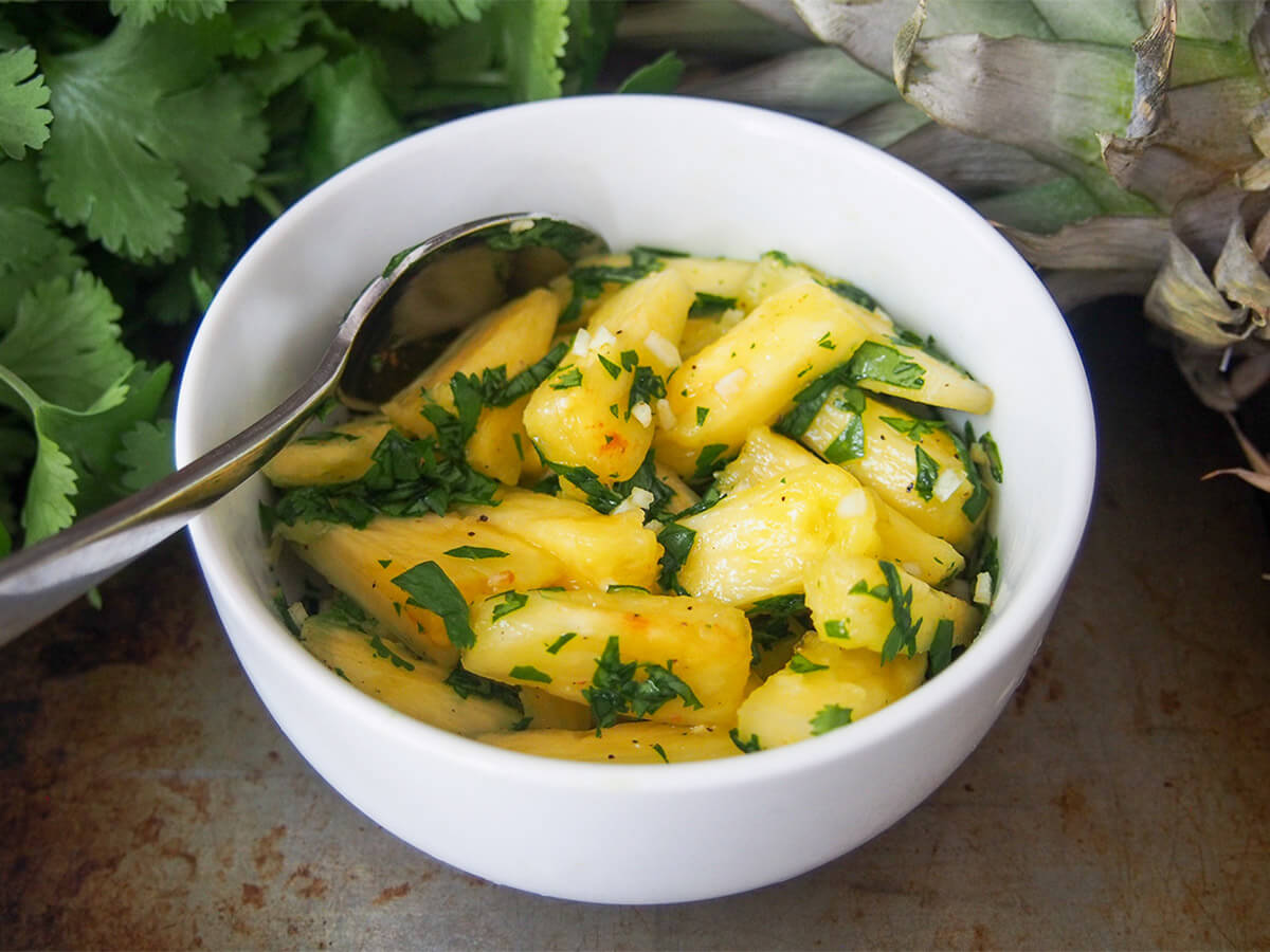 bowl of pineapple chow with spoon in side of bowl