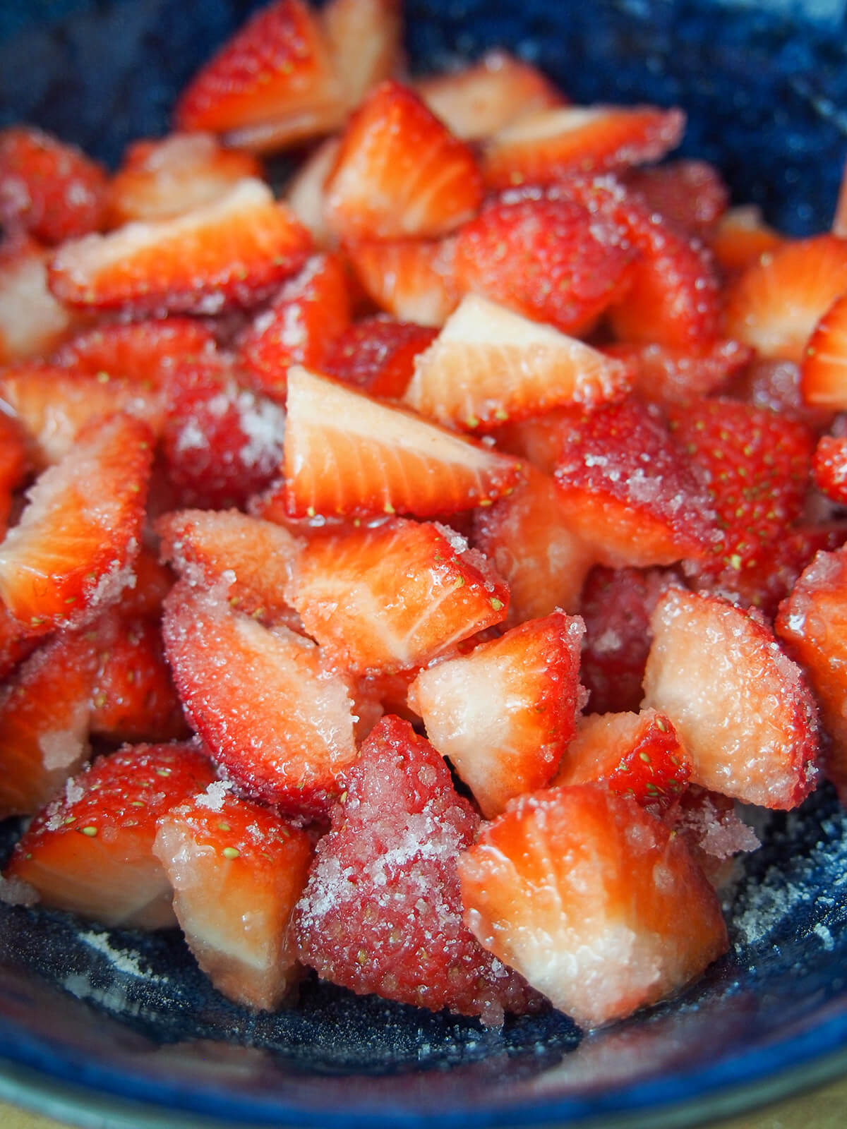bowl of chopped strawberries with sugar over them