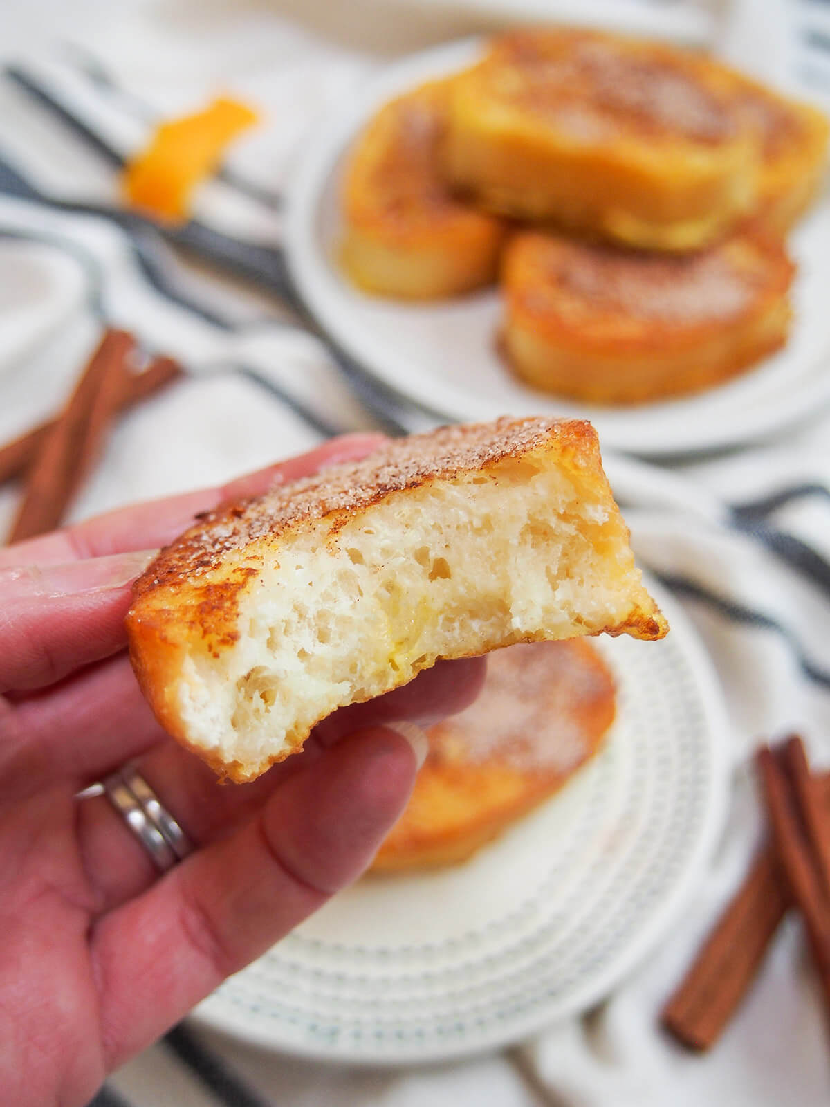 holding a bitten into piece of torrijas