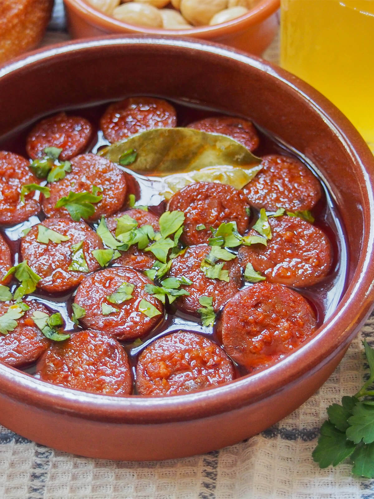 side view of dish of chorizo a la sidra (chorizo in cider)