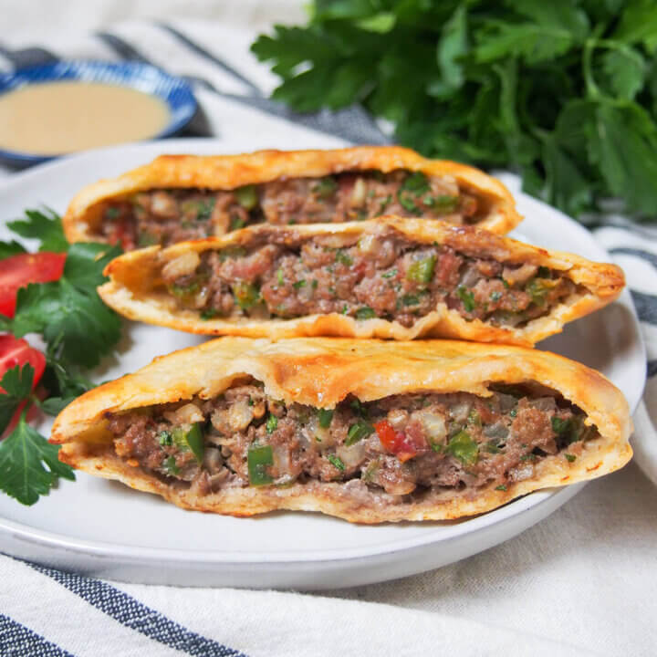 three hawawshi meat filled pita