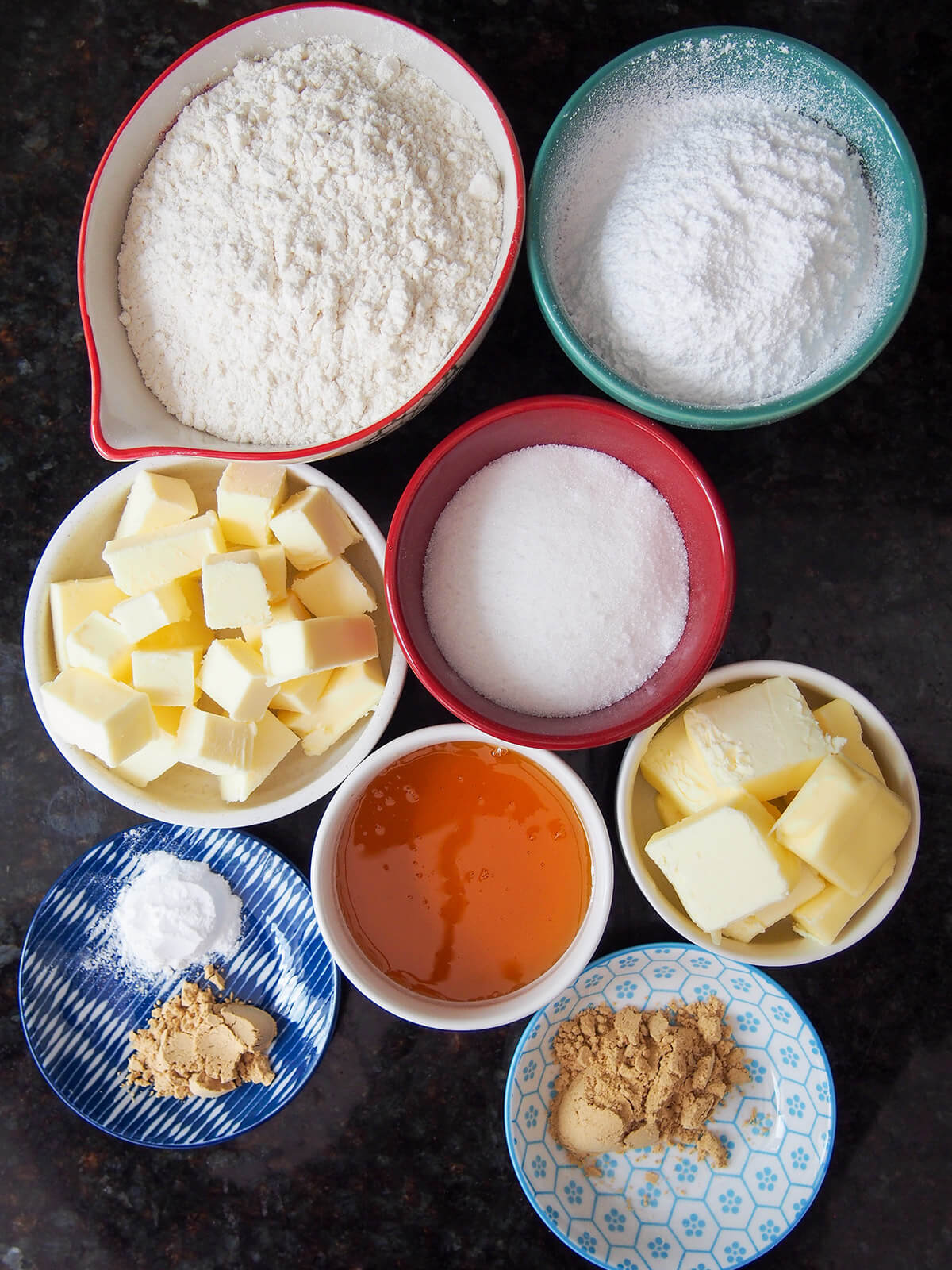bowls of flour, butter, sugar, ginger and golden syrup