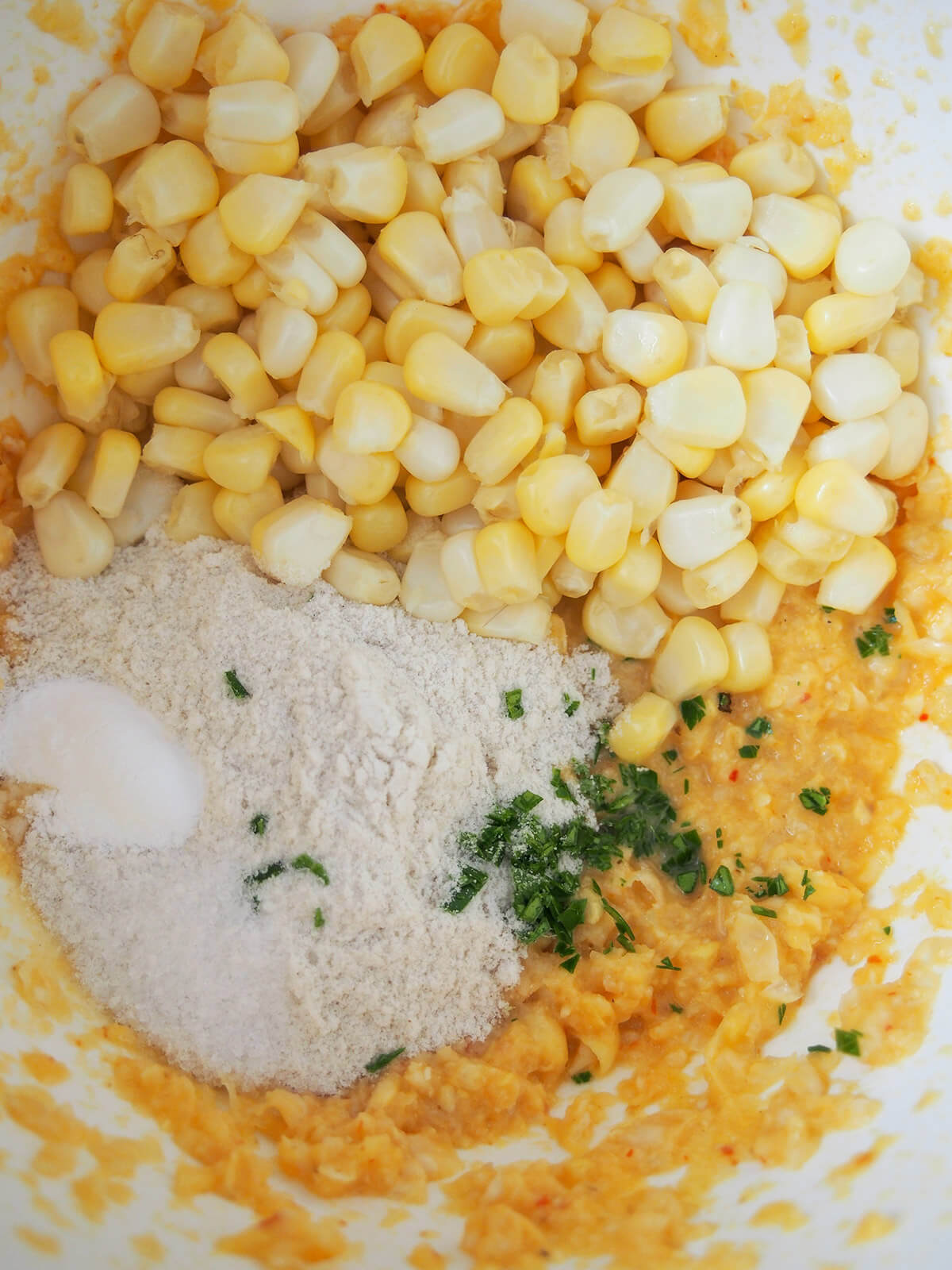 bowl with corn, pureed corn mixture, flour and shredded lime leaves