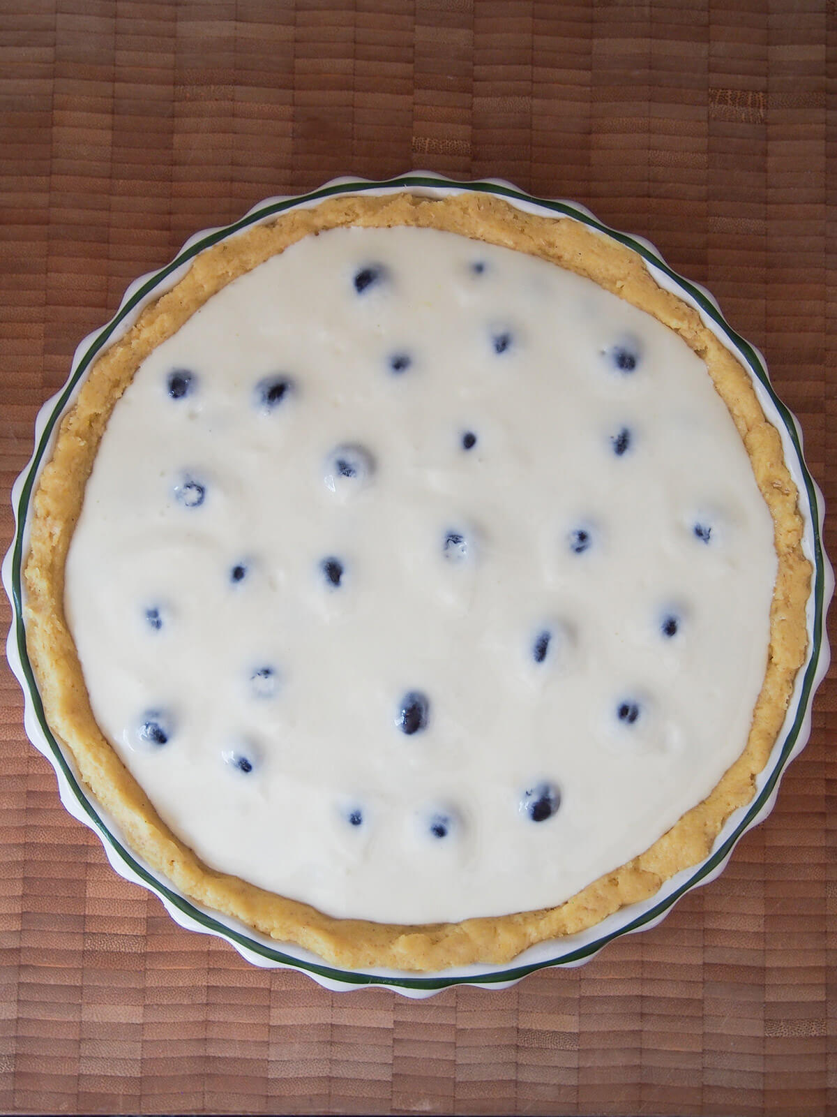 creamy mixture over top of blueberries before baking
