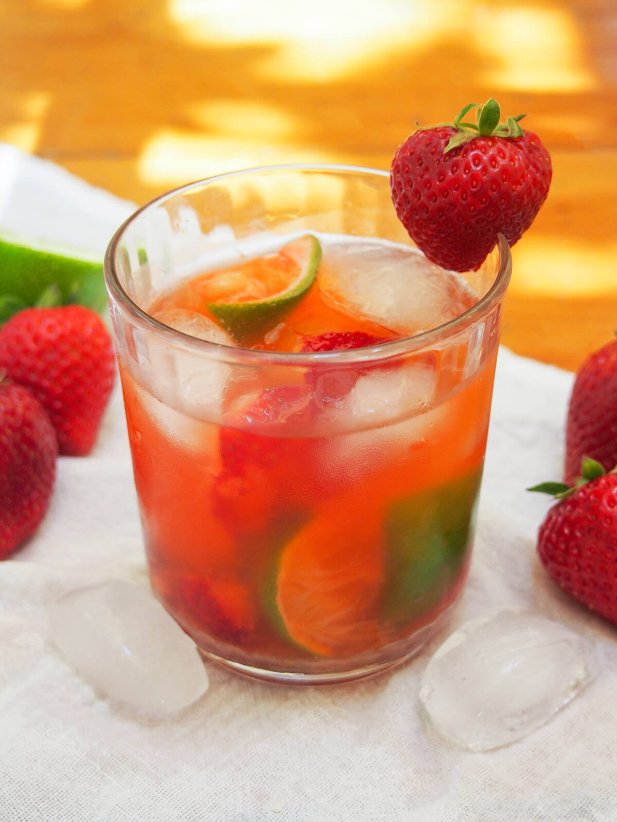 side view of glass of strawberry caipirinha