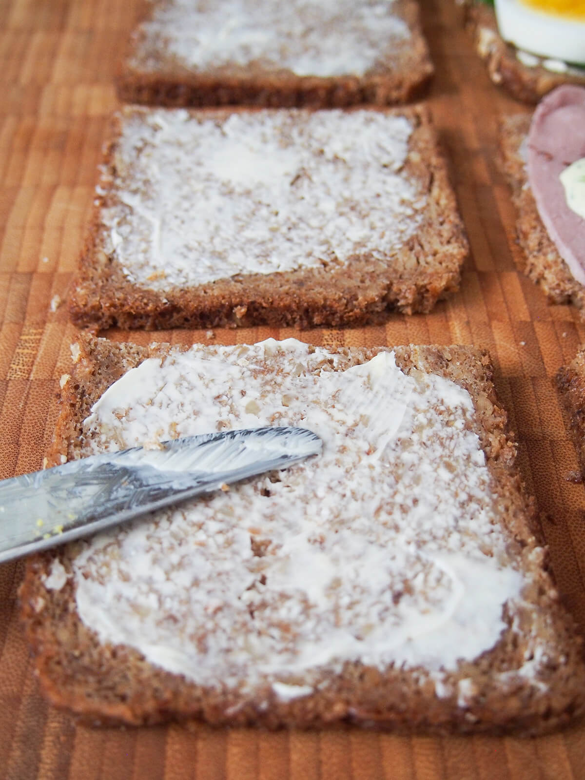 buttering slices of rye bread