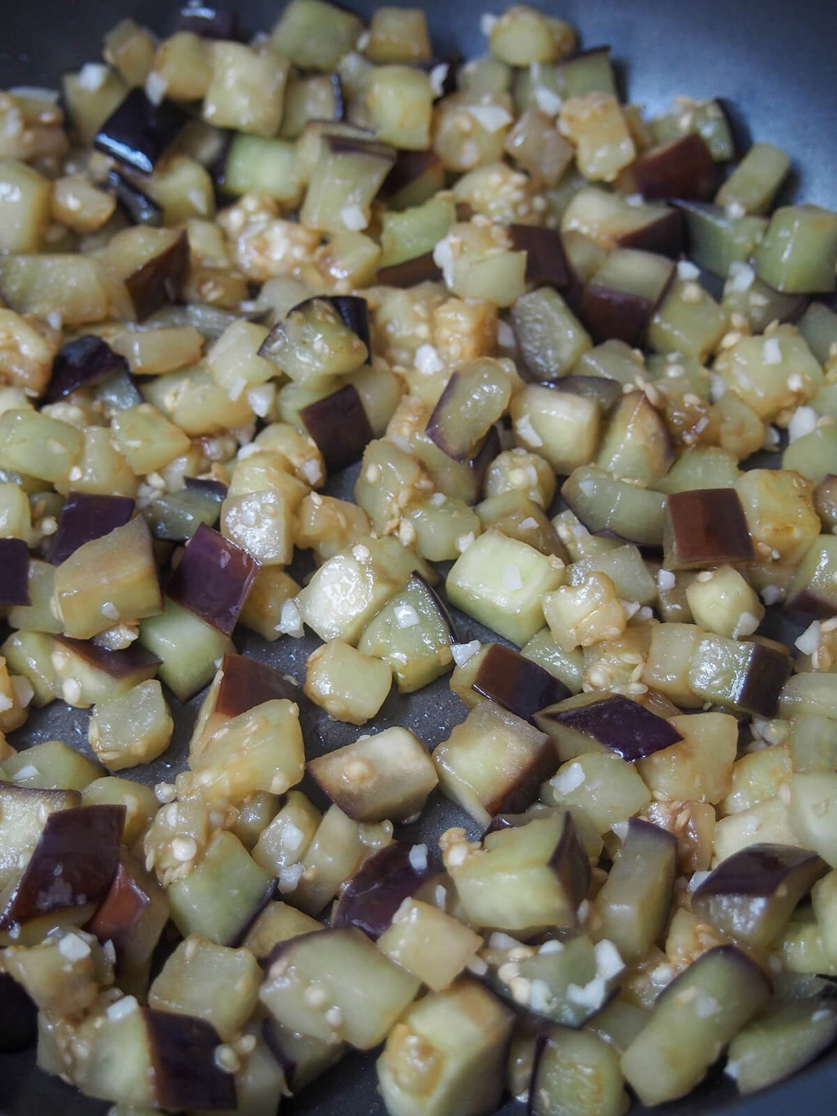 cooking diced eggplant in skillet