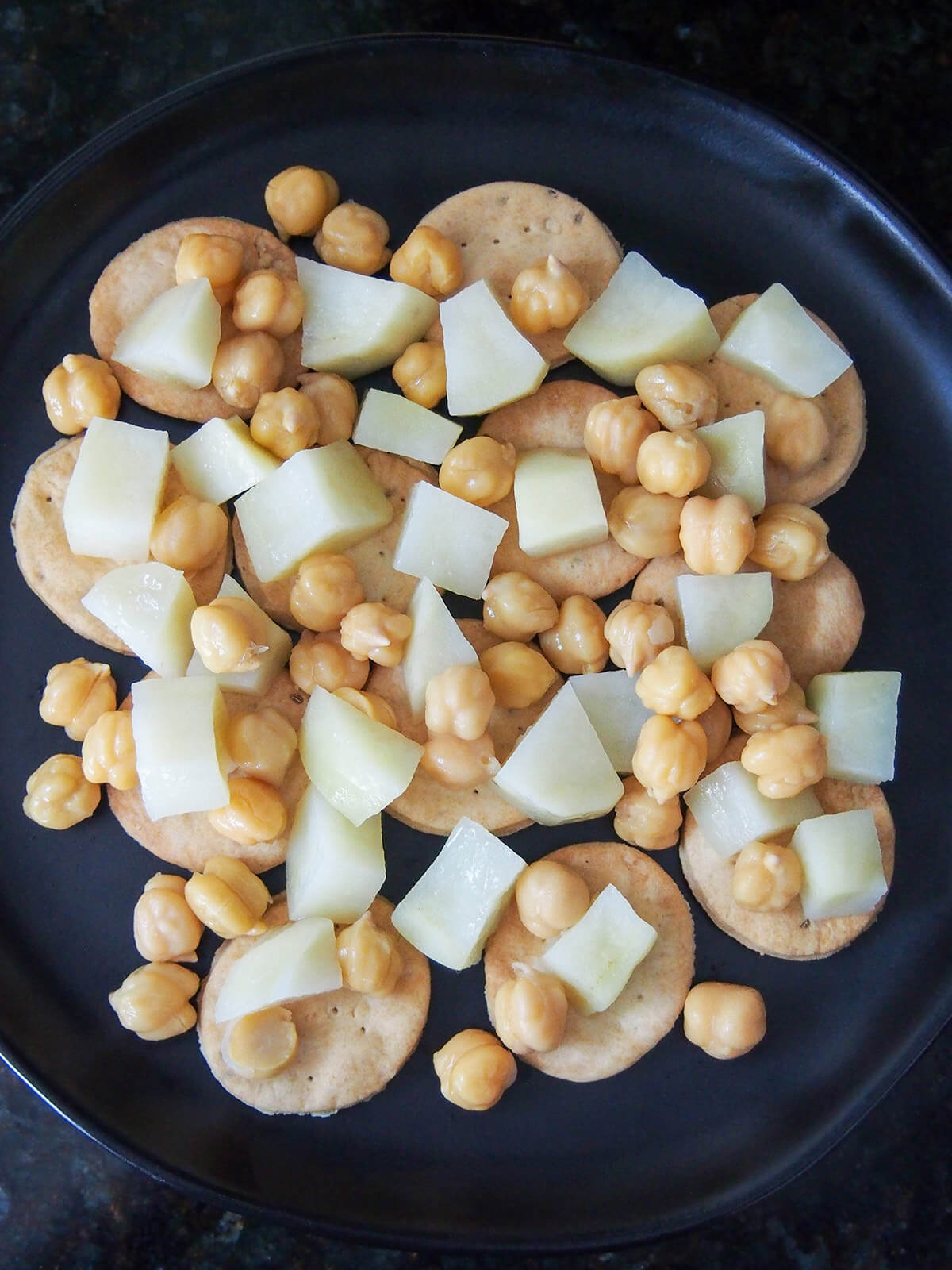 crackers, potato and chickpeas on plate