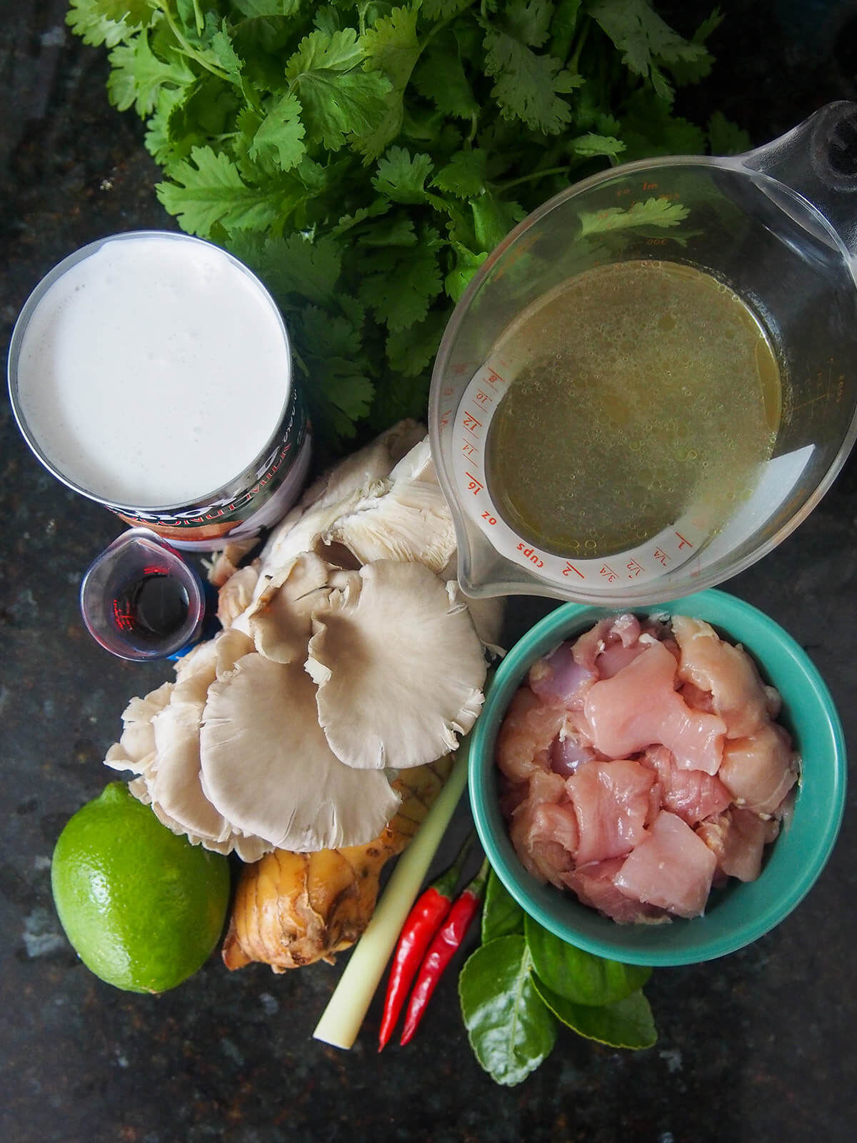 measure with stock, bowl of chopped chicken spices, cilantro, lime, oyster mushrooms