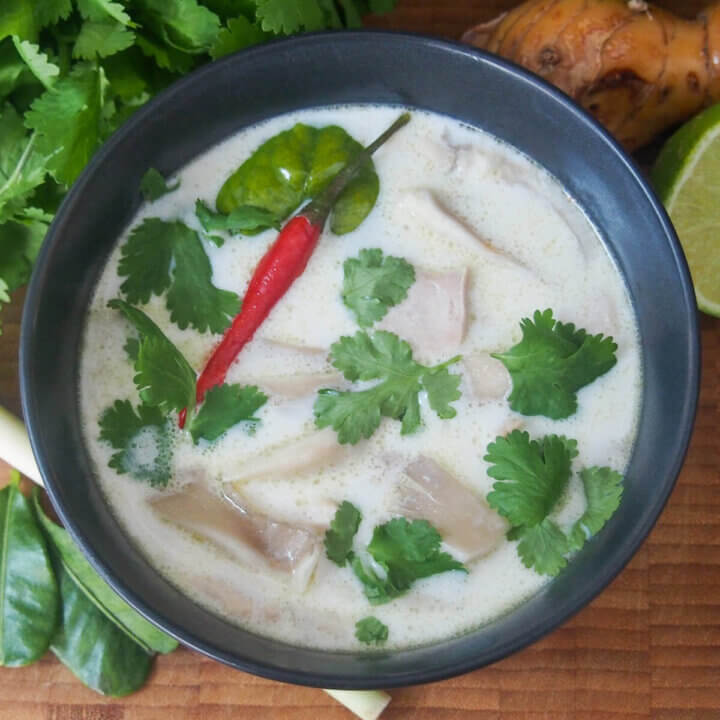 overhead view of bowl of tom kha gai Thai coconut soup