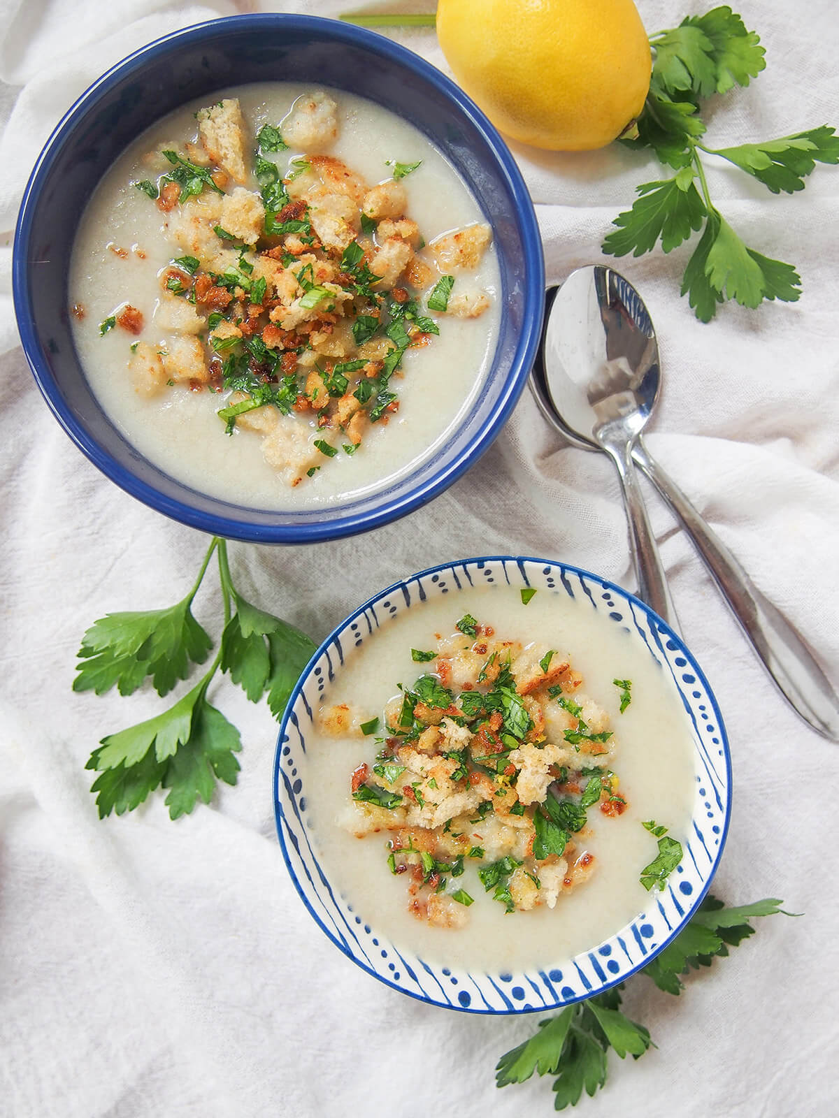 overhead view of a blue bowl and white and blue patterned bowl both with Jerusalem artichoke soup