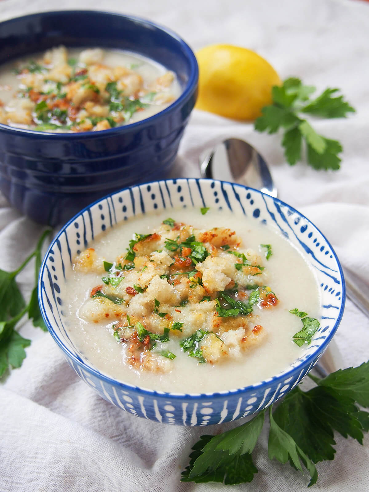 bowl of Jerusalem artichoke soup with blue bowl of soup behind it