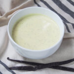 bowl of Vanillesosse German vanilla sauce with vanilla pods below