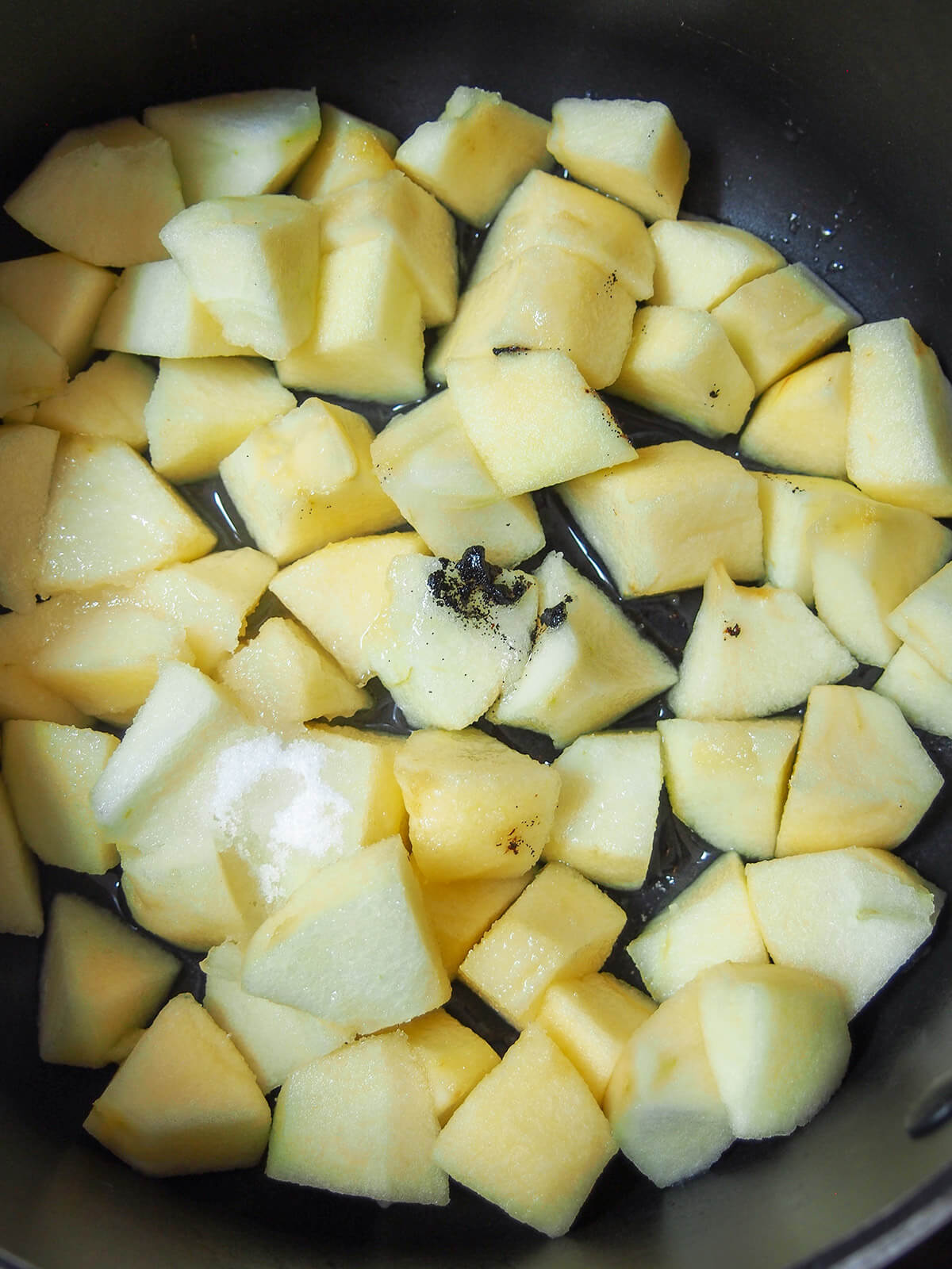 chunks of apple with vanilla seeds and sugar on top