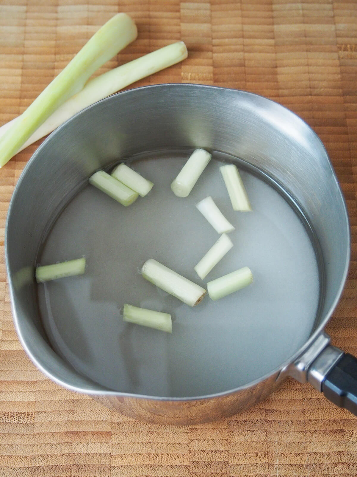 chunks of lemongrass, sugar and water in pan