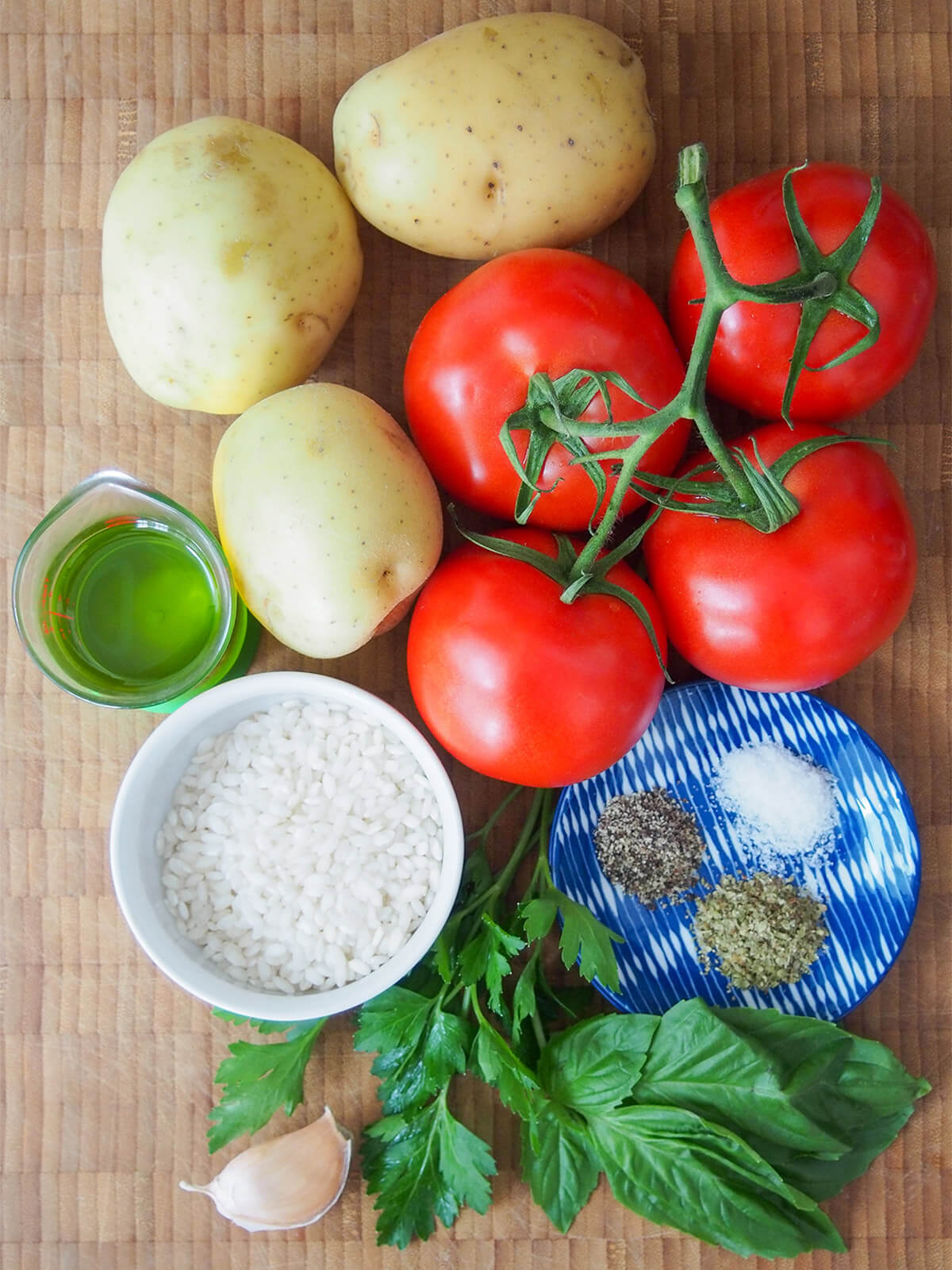 tomatoes, potatoes, rice, oil and herbs on board from overhead