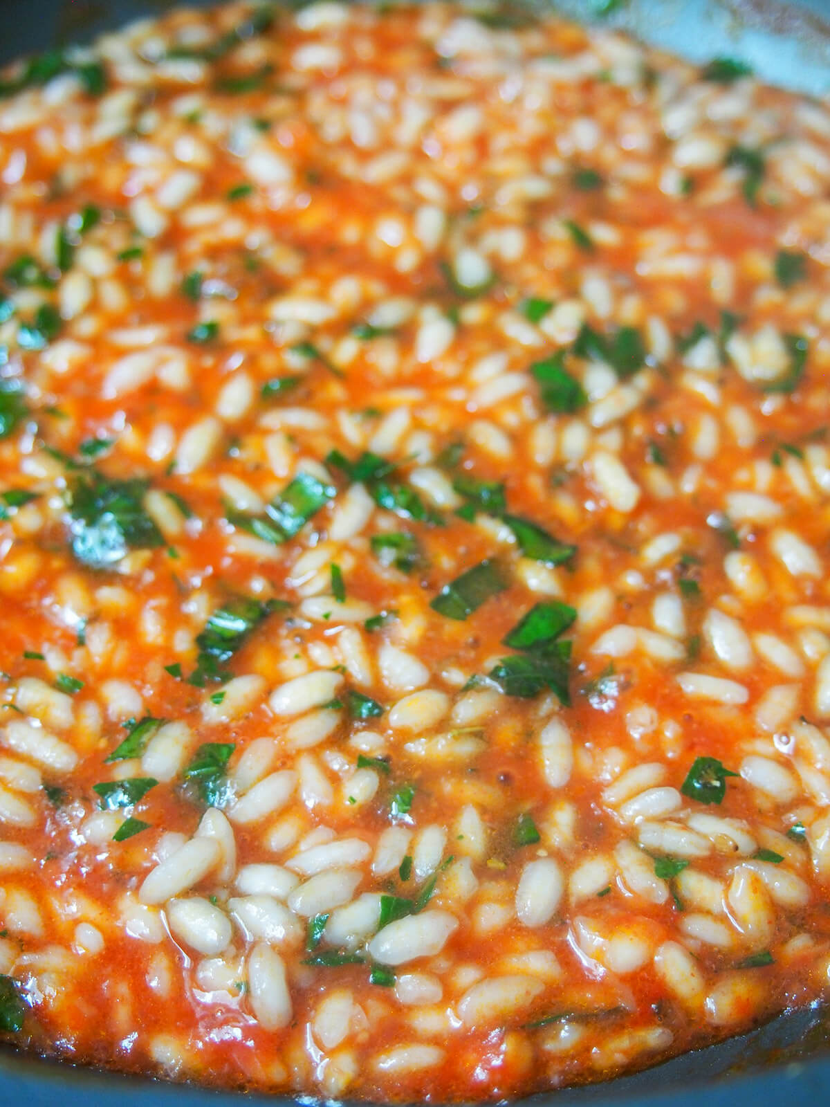 par-cooking rice in tomato pulp for tomatoes stuffed with rice