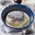 bowl of Germknödel served with vanilla sauce.