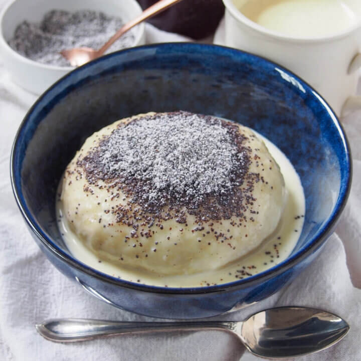 bowl of Germknödel served with vanilla sauce.