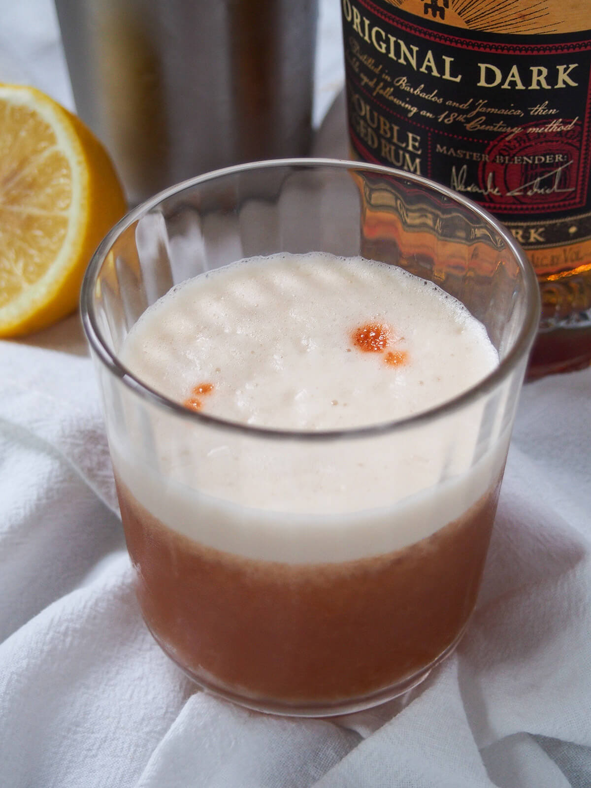 glass of rum sour from side.