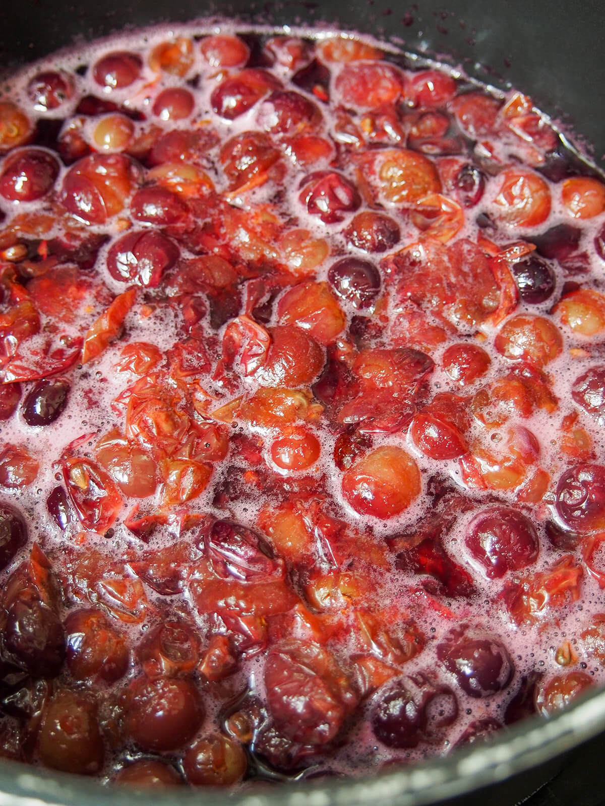 simmering grapes in pot.
