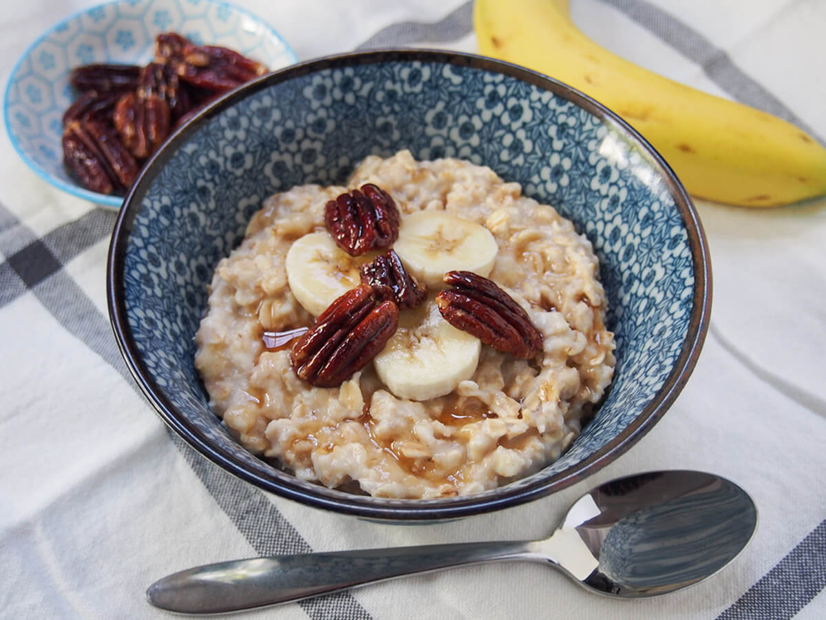 bowl of banana oatmeal with spoon under bowl.