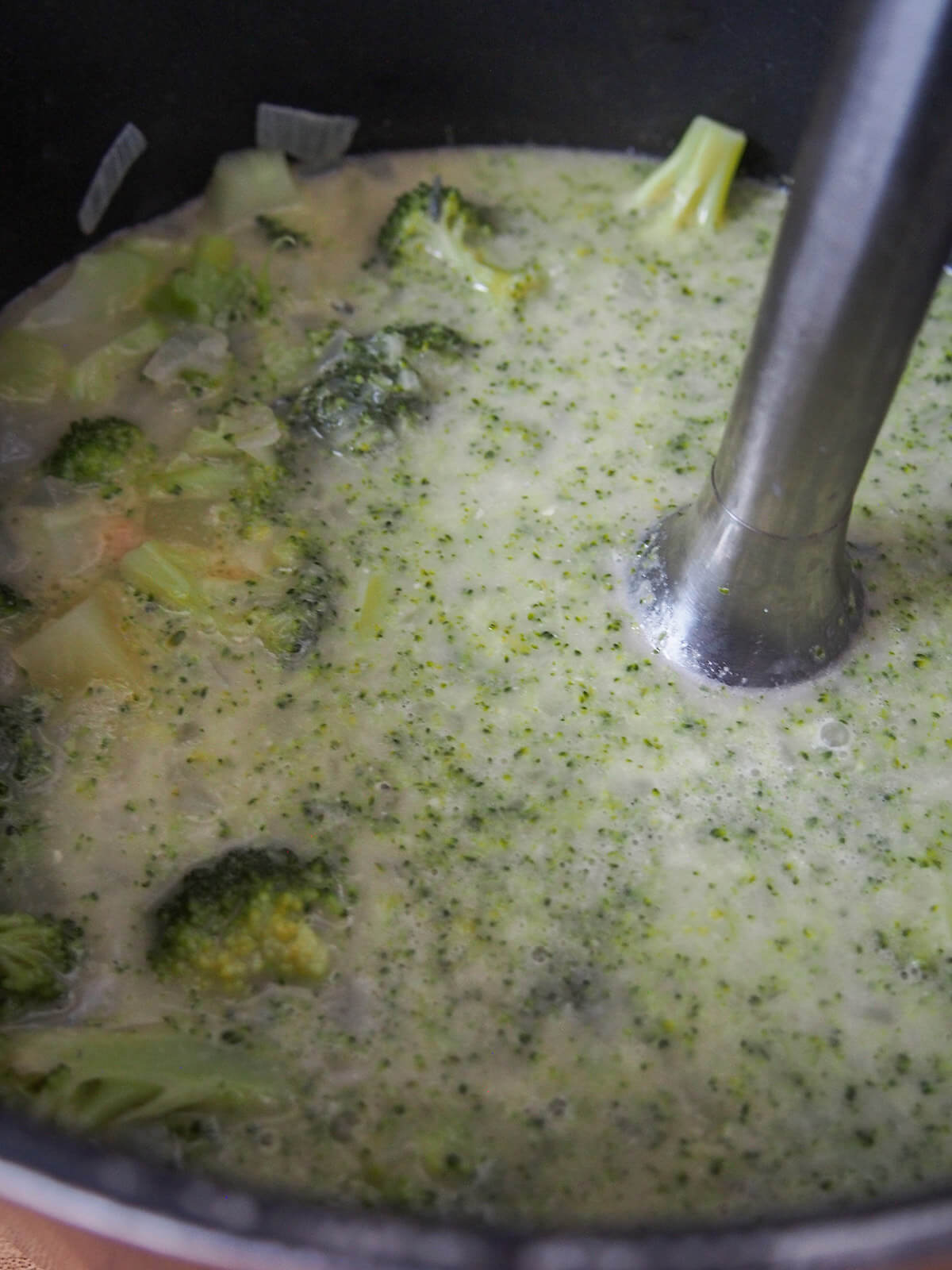 using immersion blender in pot of soup.