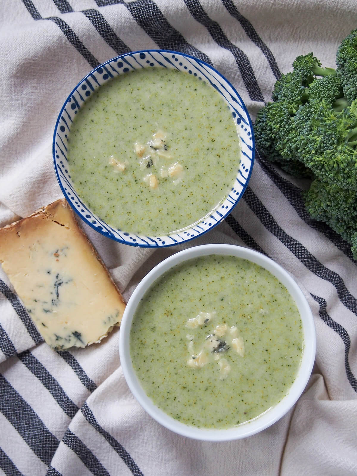 two bowls of broccoli and stilton soup from overhead