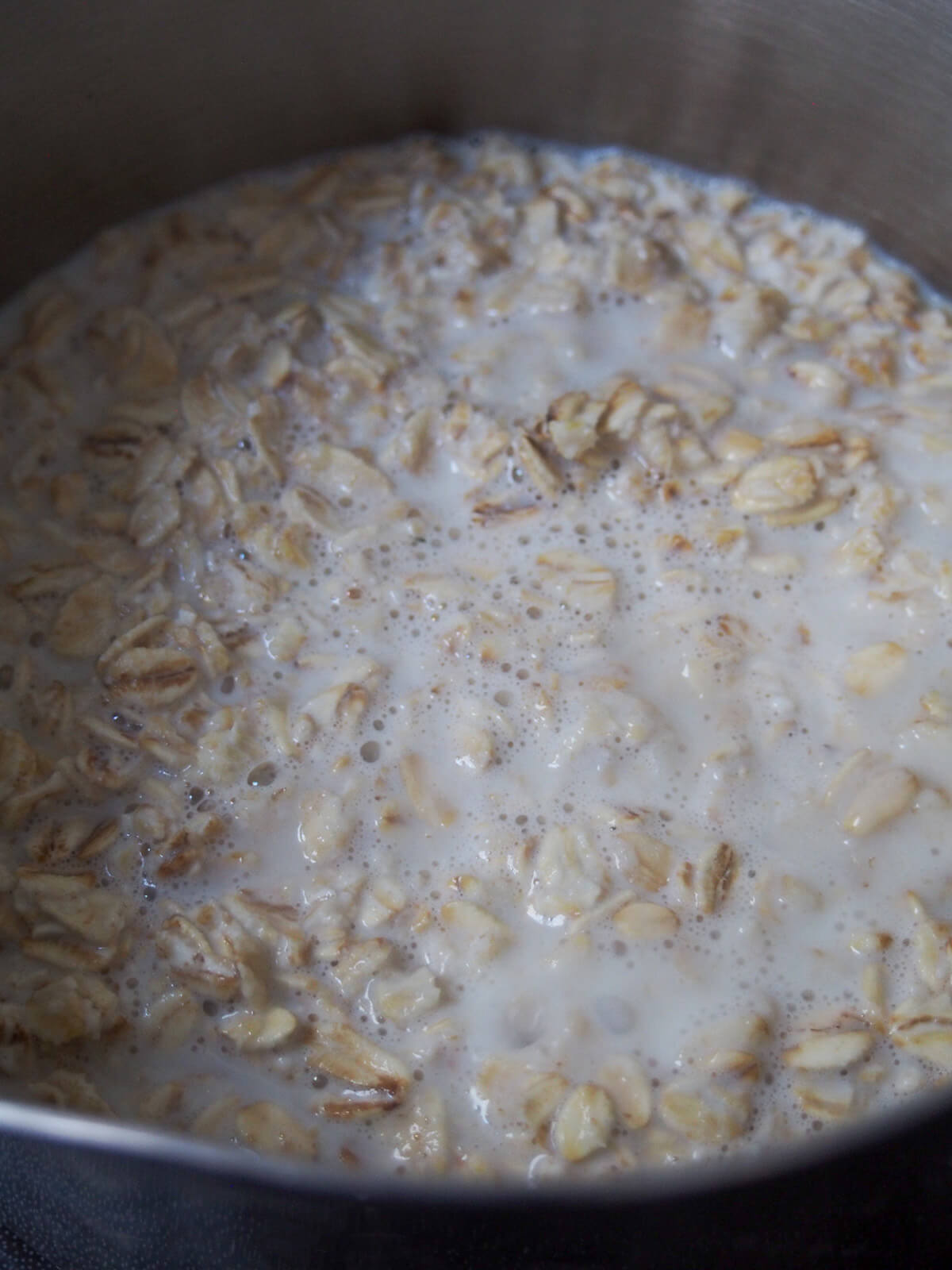 oatmeal and milk simmering in pan.