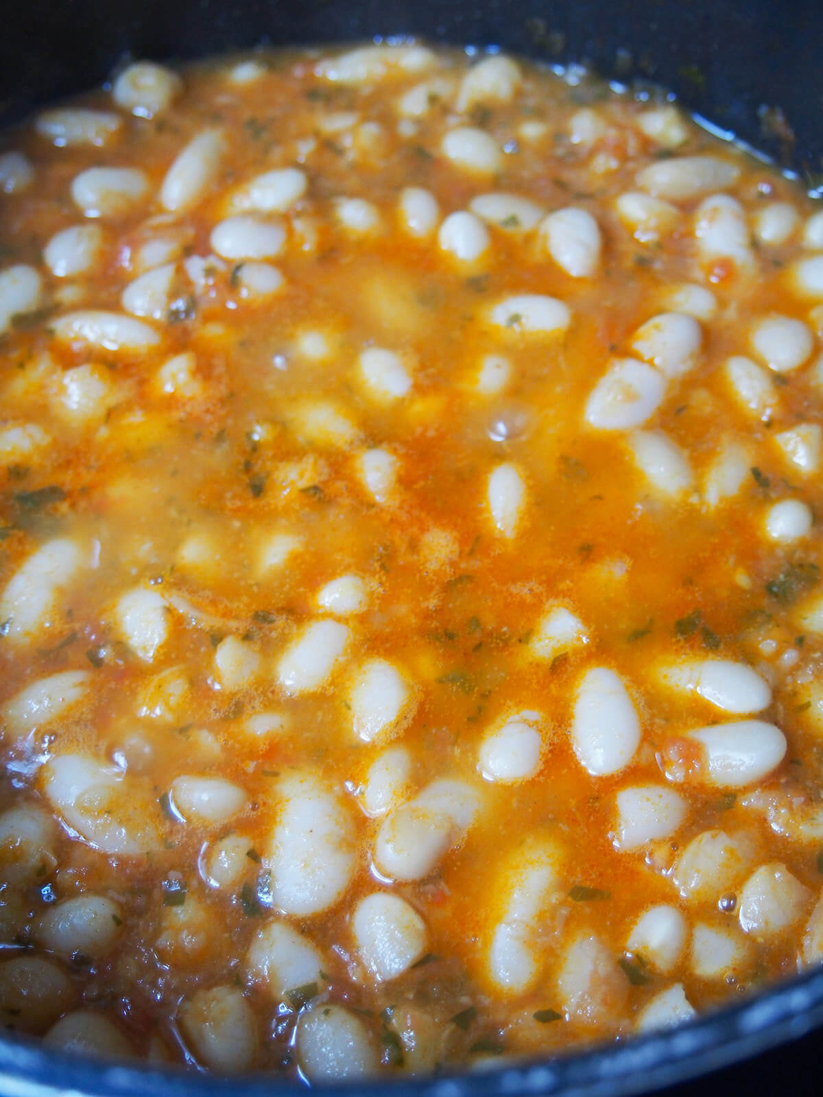 simmering pot of beans and sauce.