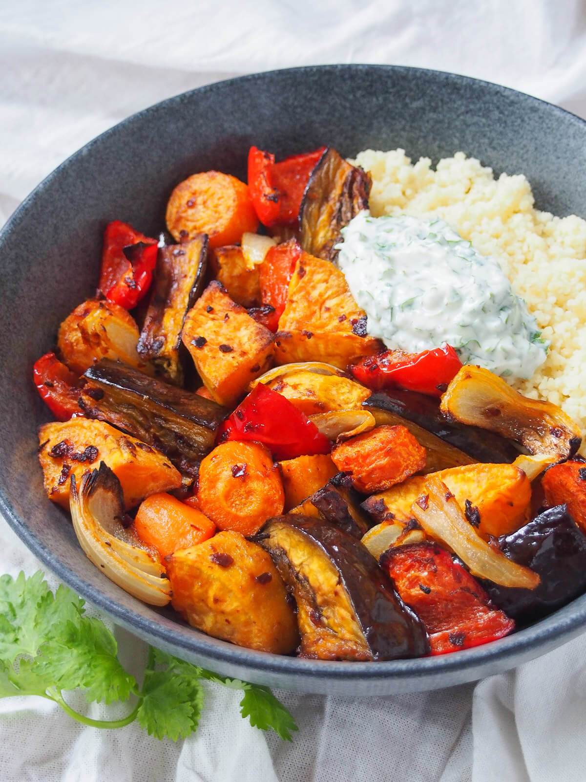 boel of harissa roasted vegetables with herb yogurt and couscous.