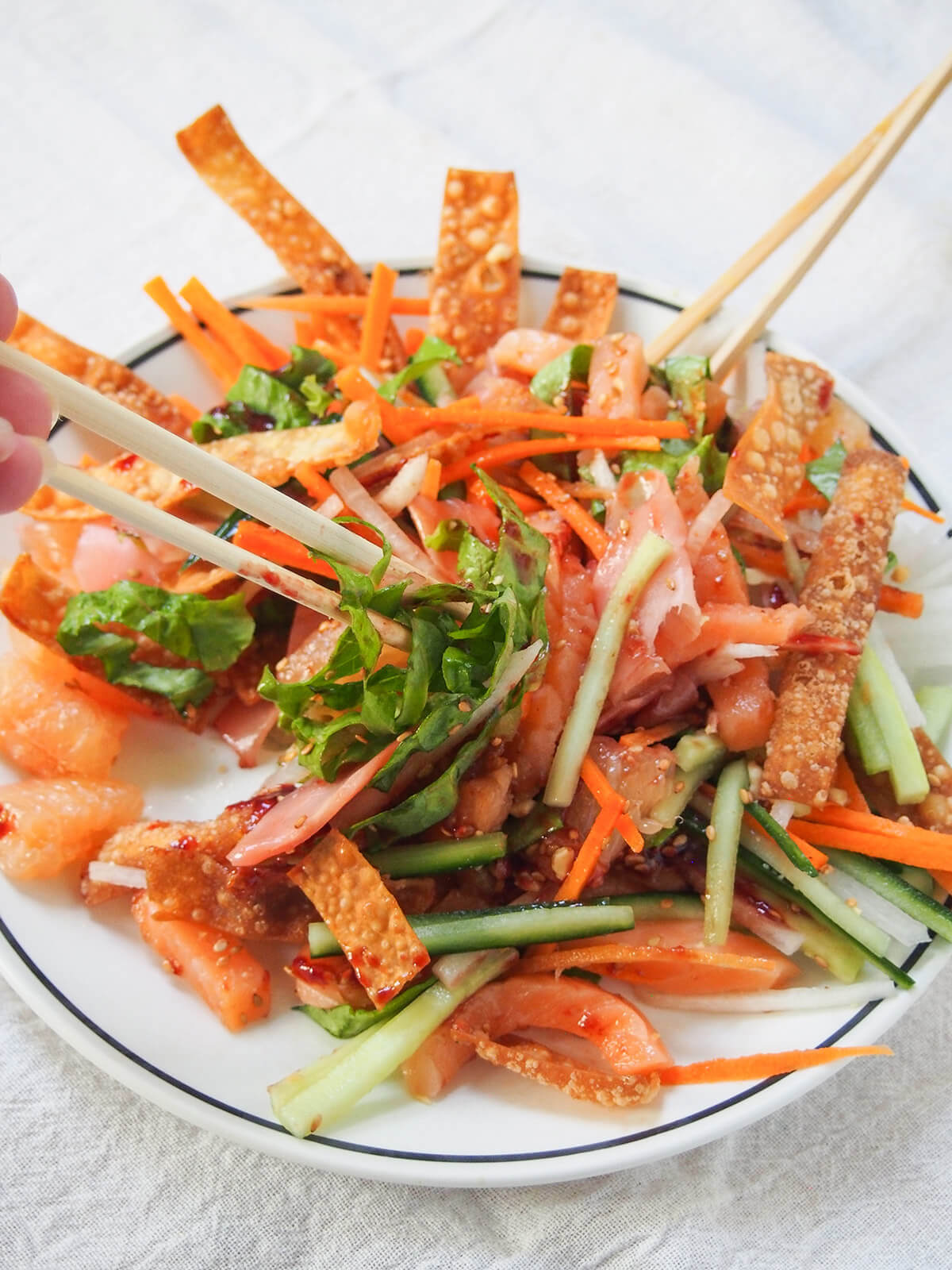tossing yee sang prosperity toss with chopsticks