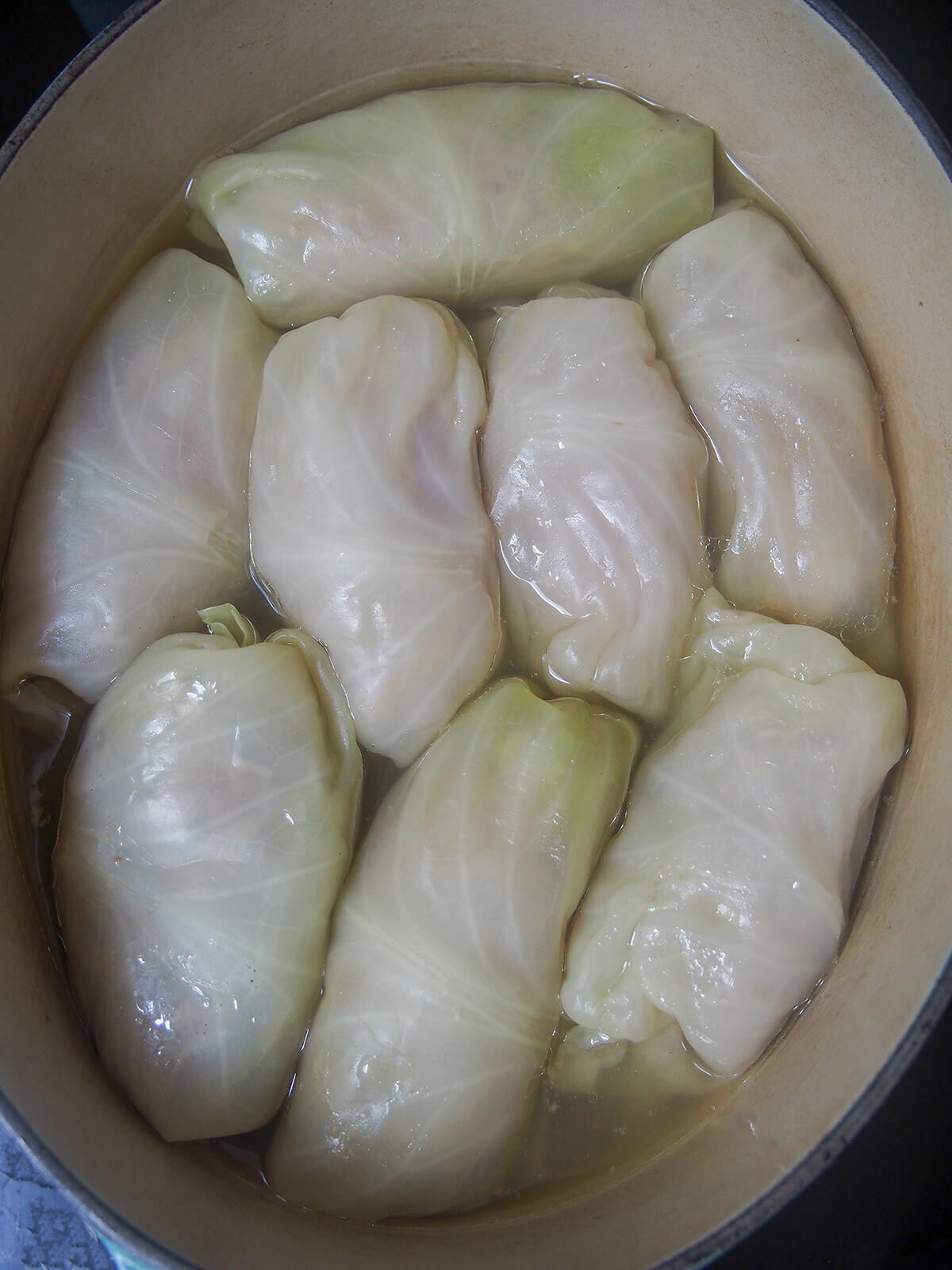 all stuffed cabbage rolls along with broth to cook them in in pot.