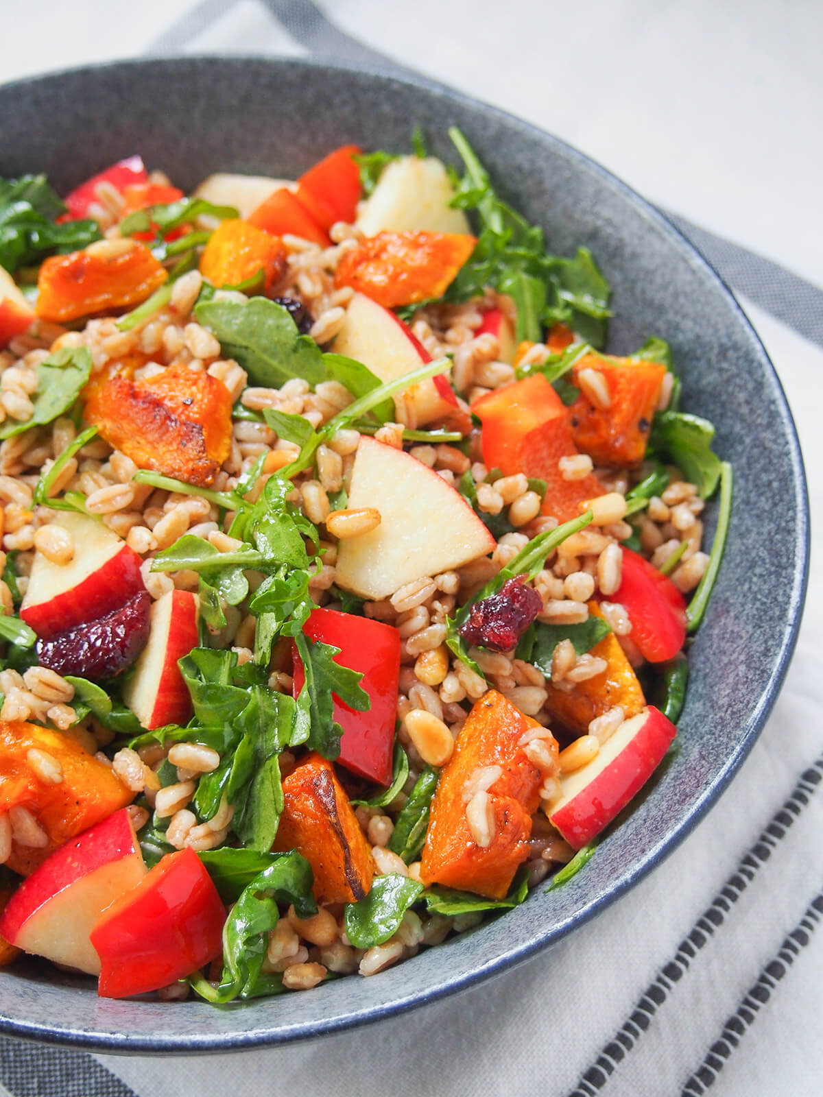 side view of grey bowl of butternut squash farro salad