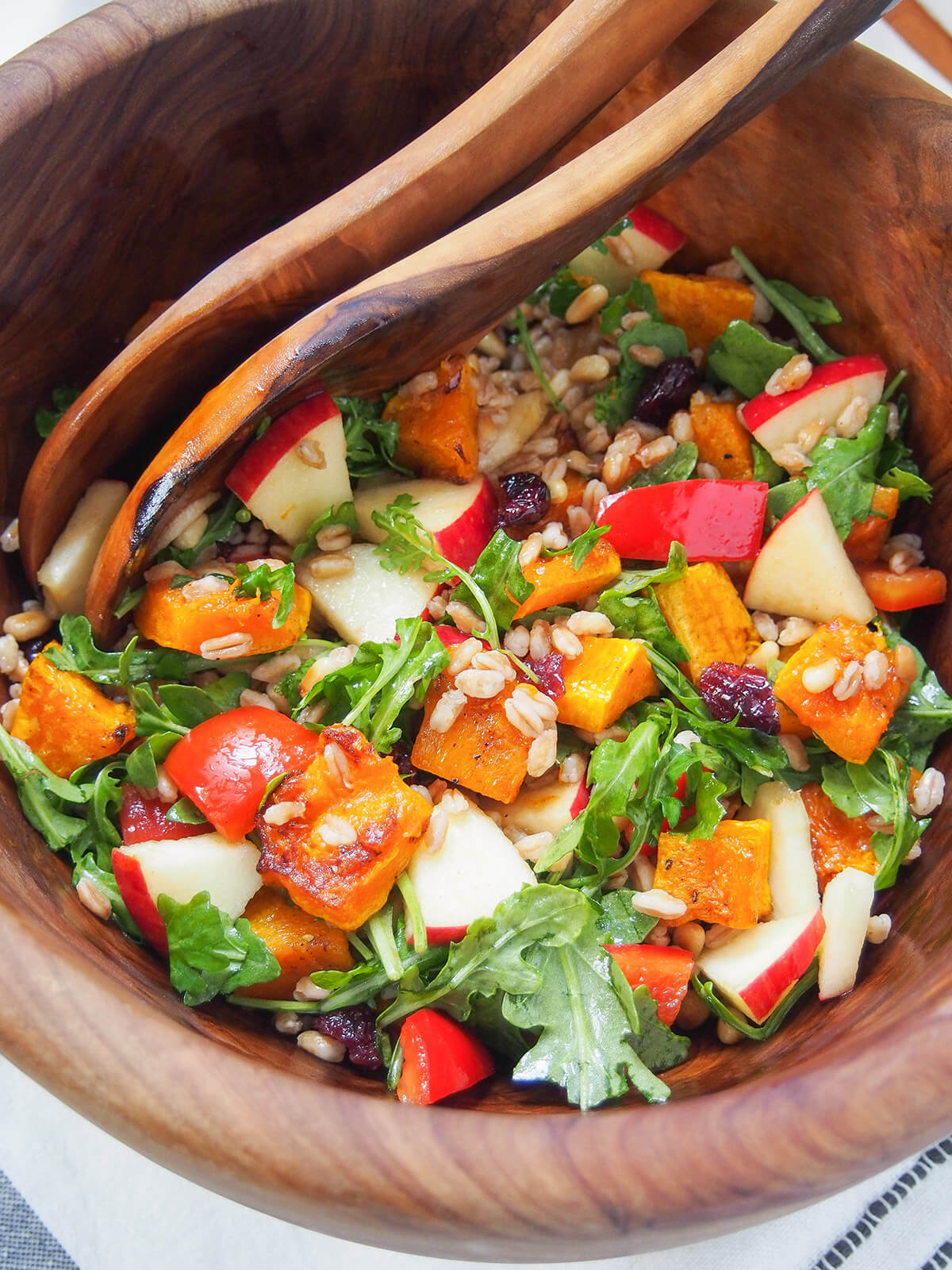 bowl with butternut squash farro salad with servers to back