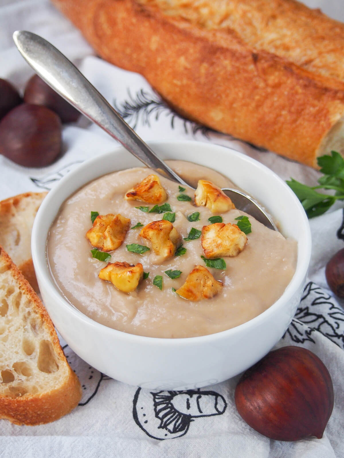 bowl of chestnut soup with spoon to back of bowl.