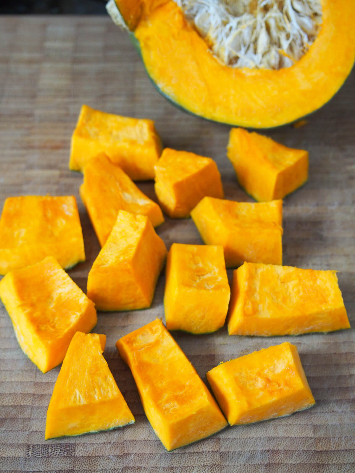 chopping kabocha squash into chunks.