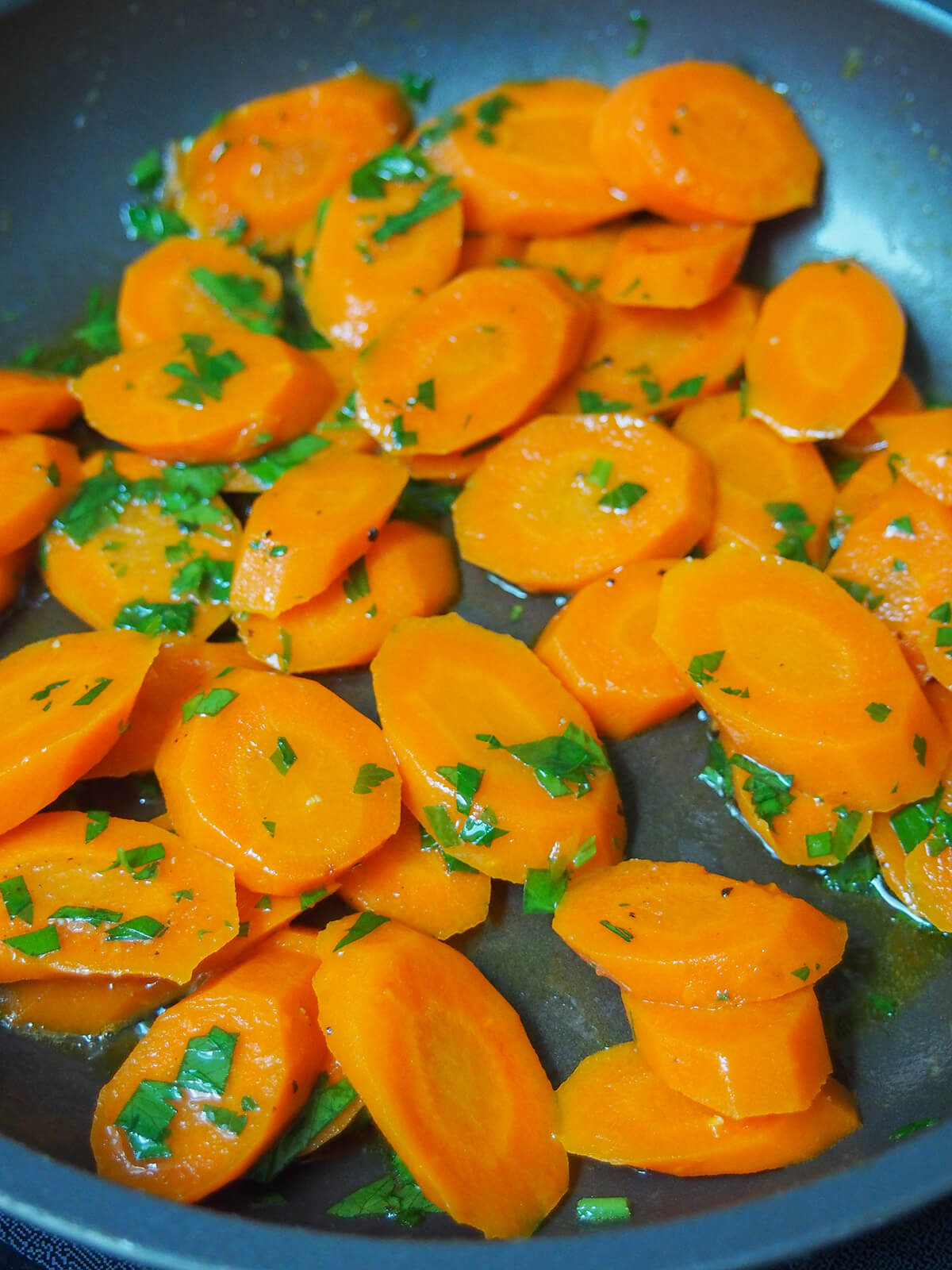 carrots in skillet with a little butter remaining and parsley added.