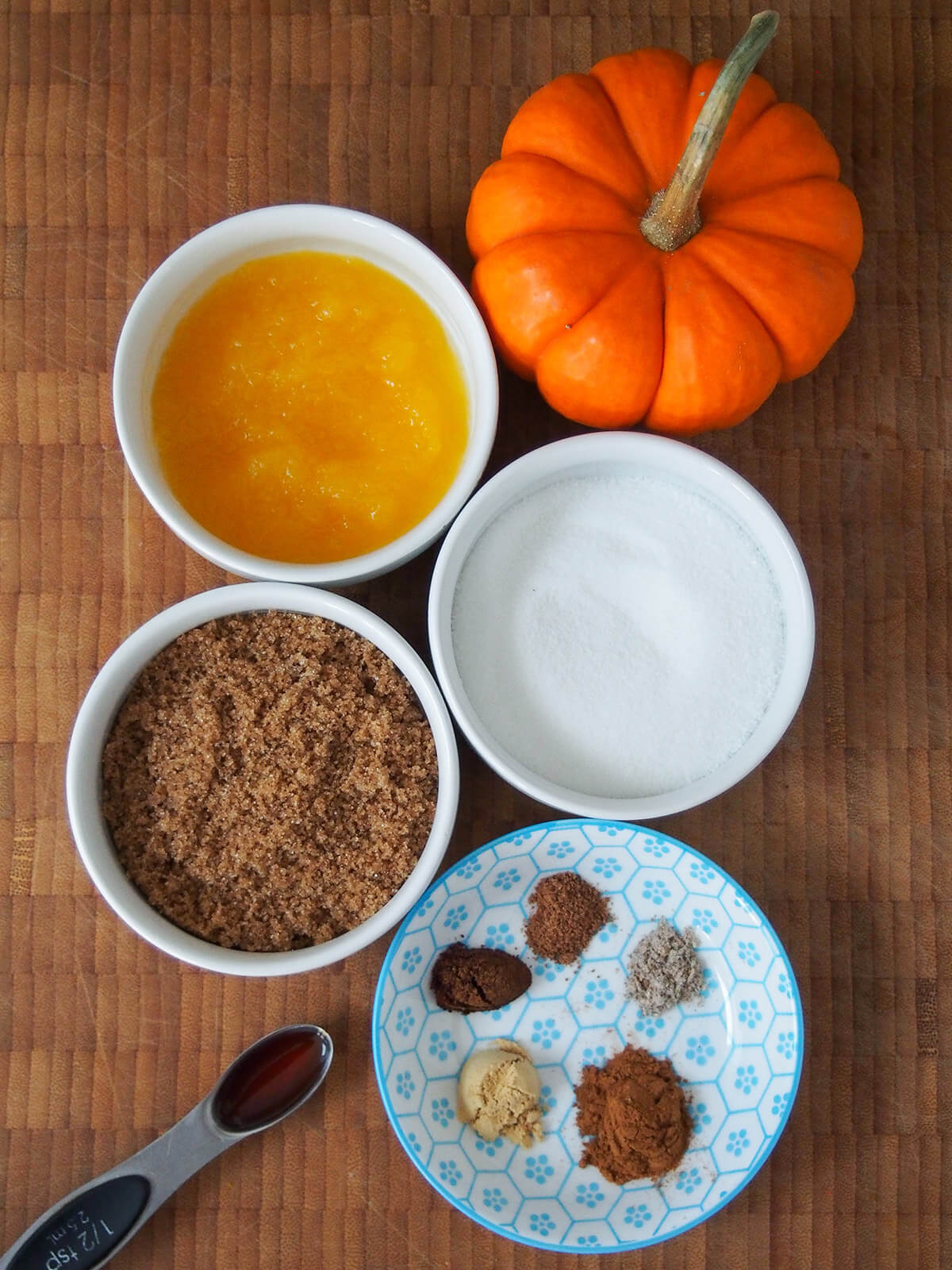 bowls with pumpkin, white and brown sugar and small dish with mounds of spices