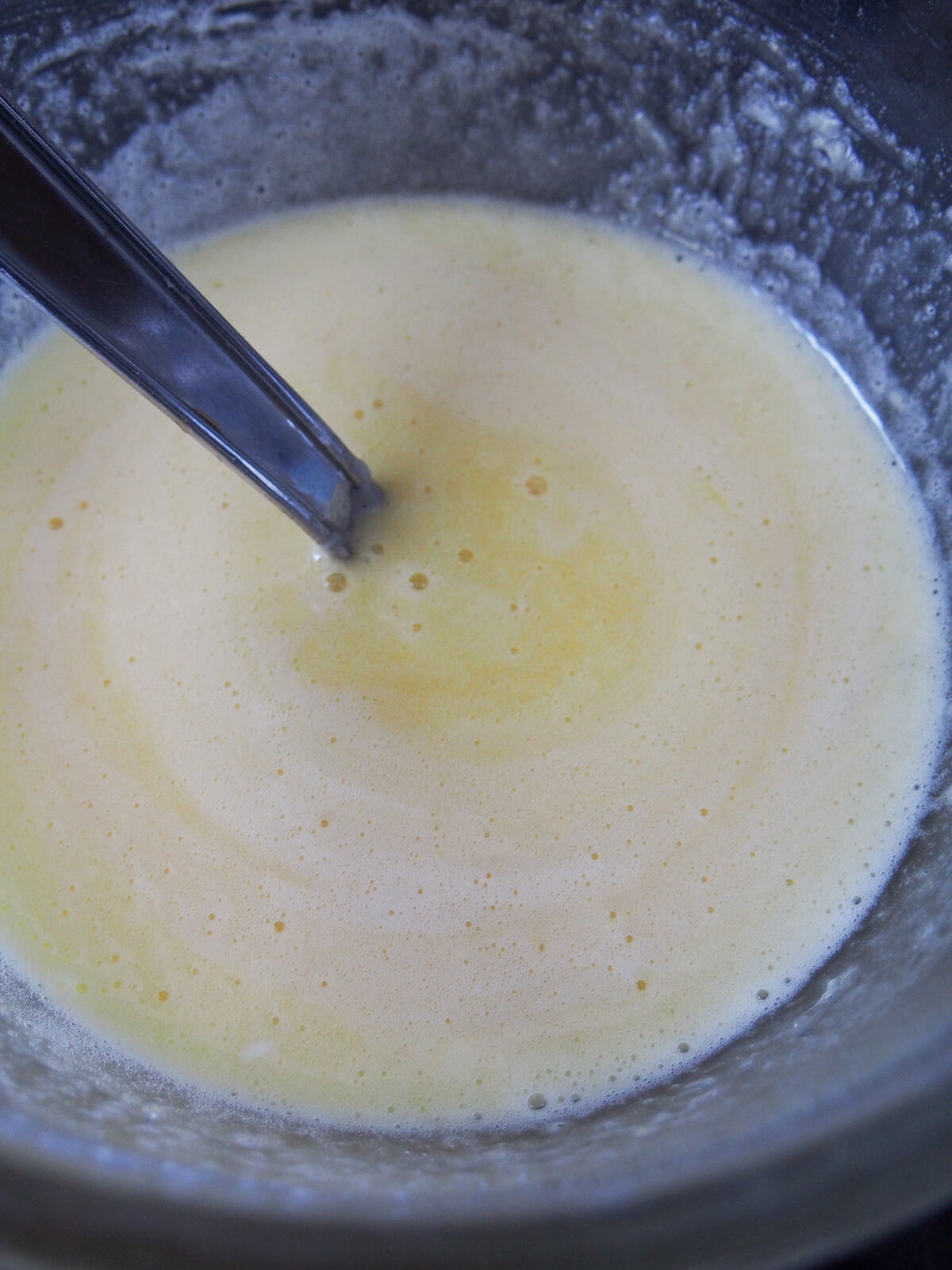whisking egg and sugar mixture for filling.