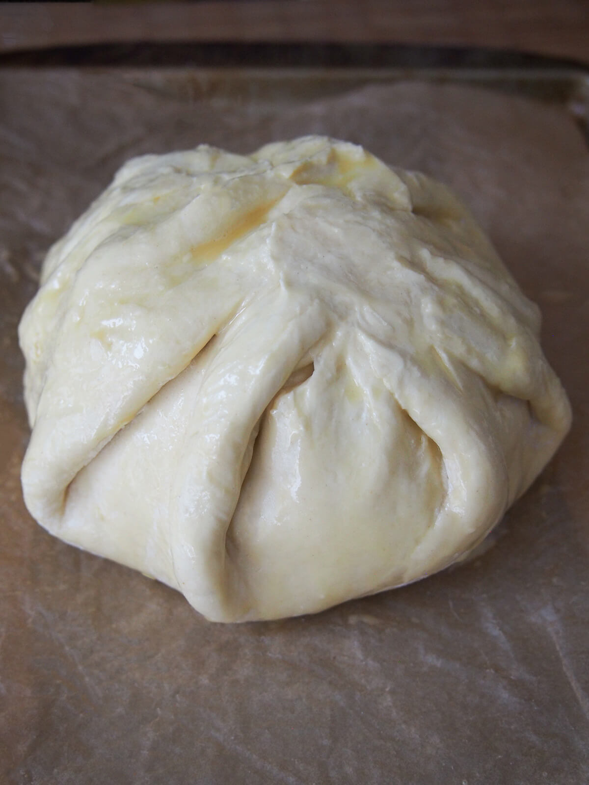 pastry wrapped around brie on baking sheet ready to bake.