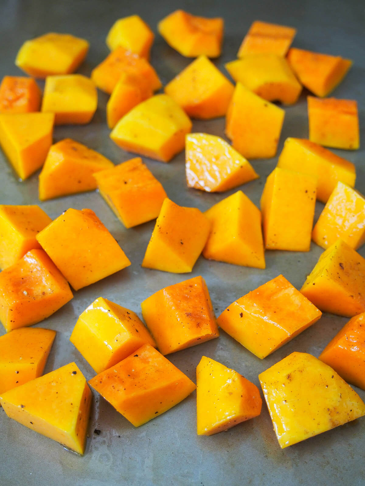 cubes of squash on baking sheet before roasting