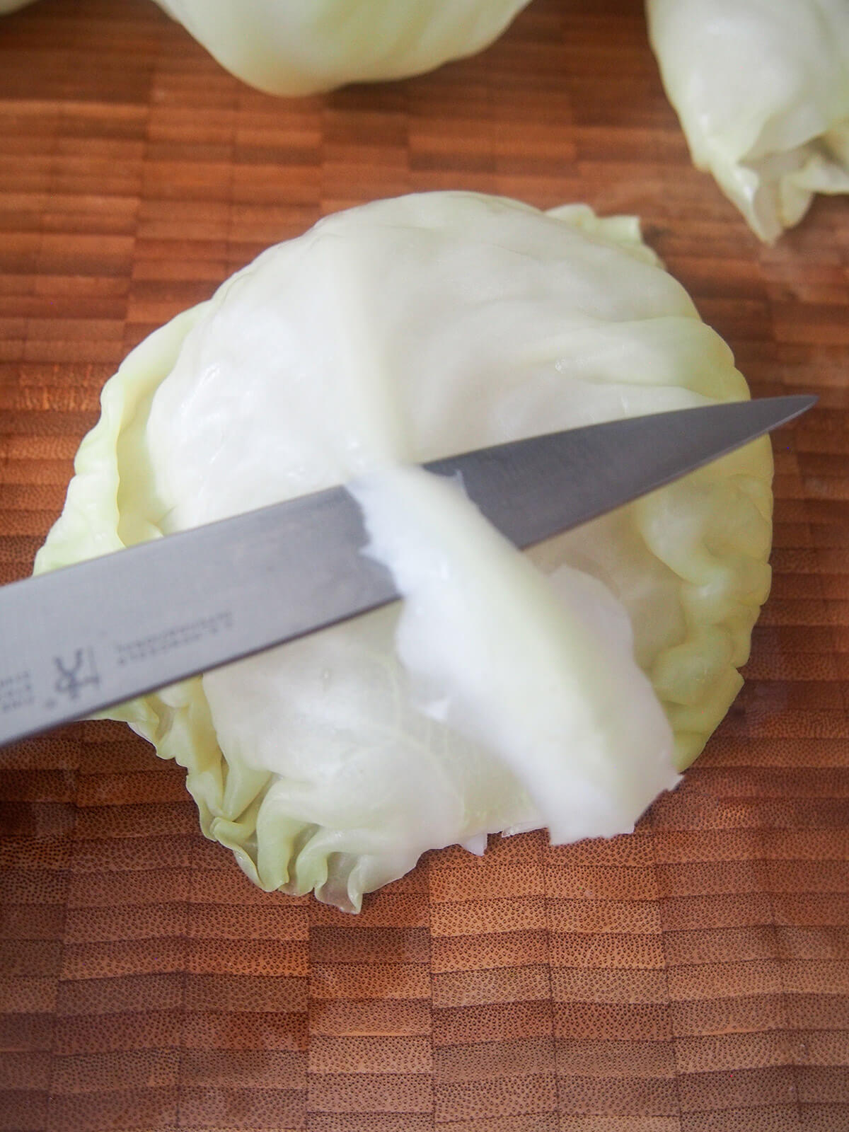 trimming stem away from cabbage leaf.