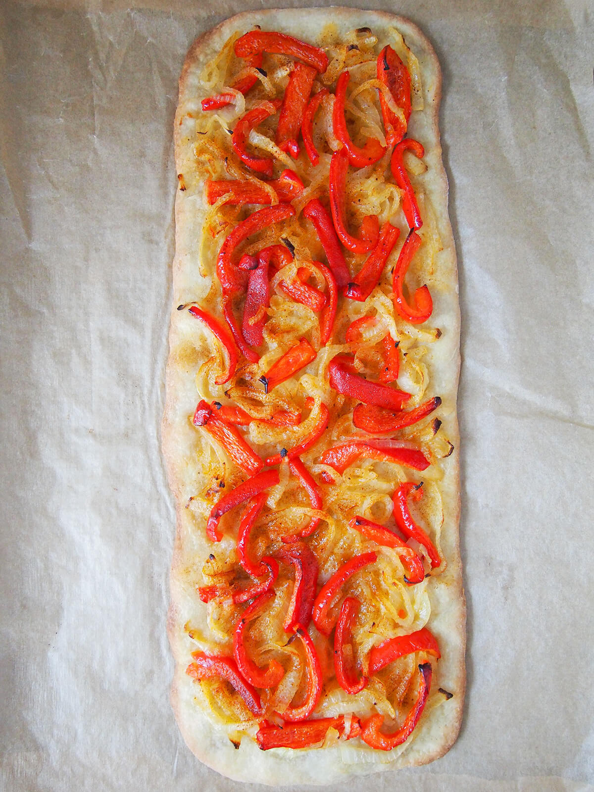 Catalan coca (Spanish pizza) on parchment just out the oven.