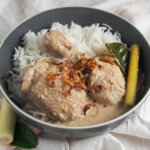 bowl of opor ayam Indonesian coconut chicken.