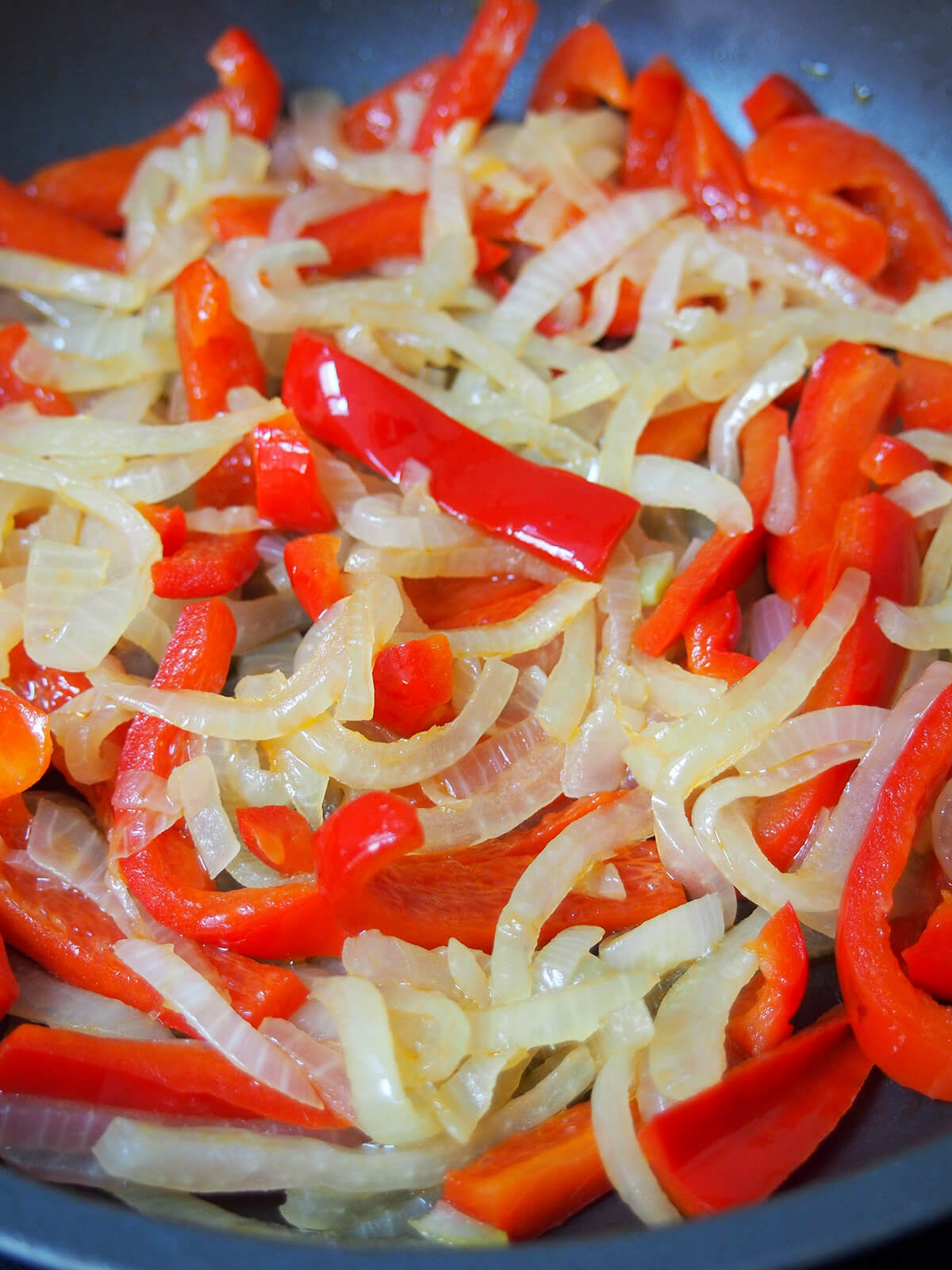 softening sliced peppers and onions in olive oil in skillet.
