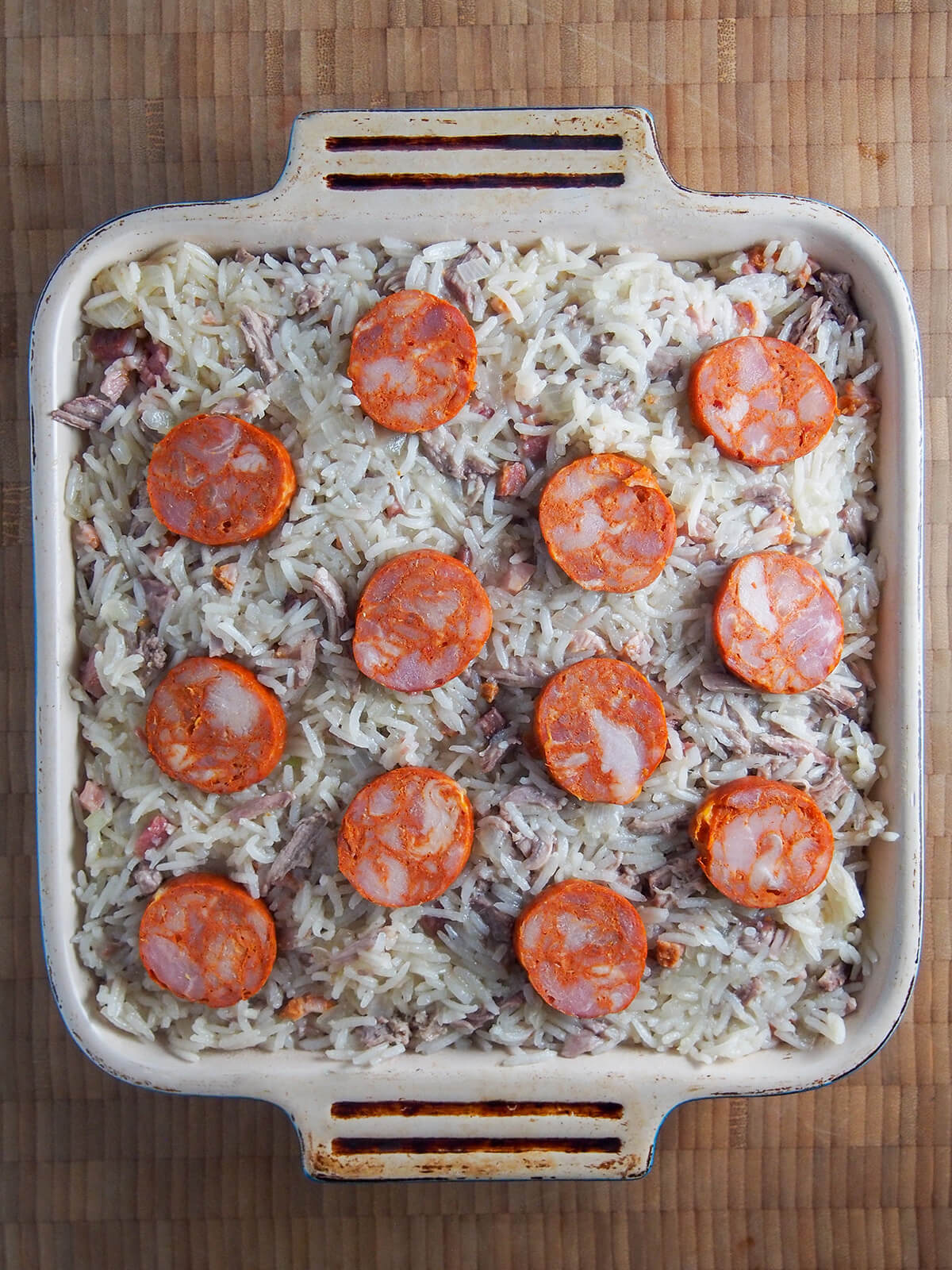 dish of arroz de pato Portuguese duck rice ready to finish in oven.