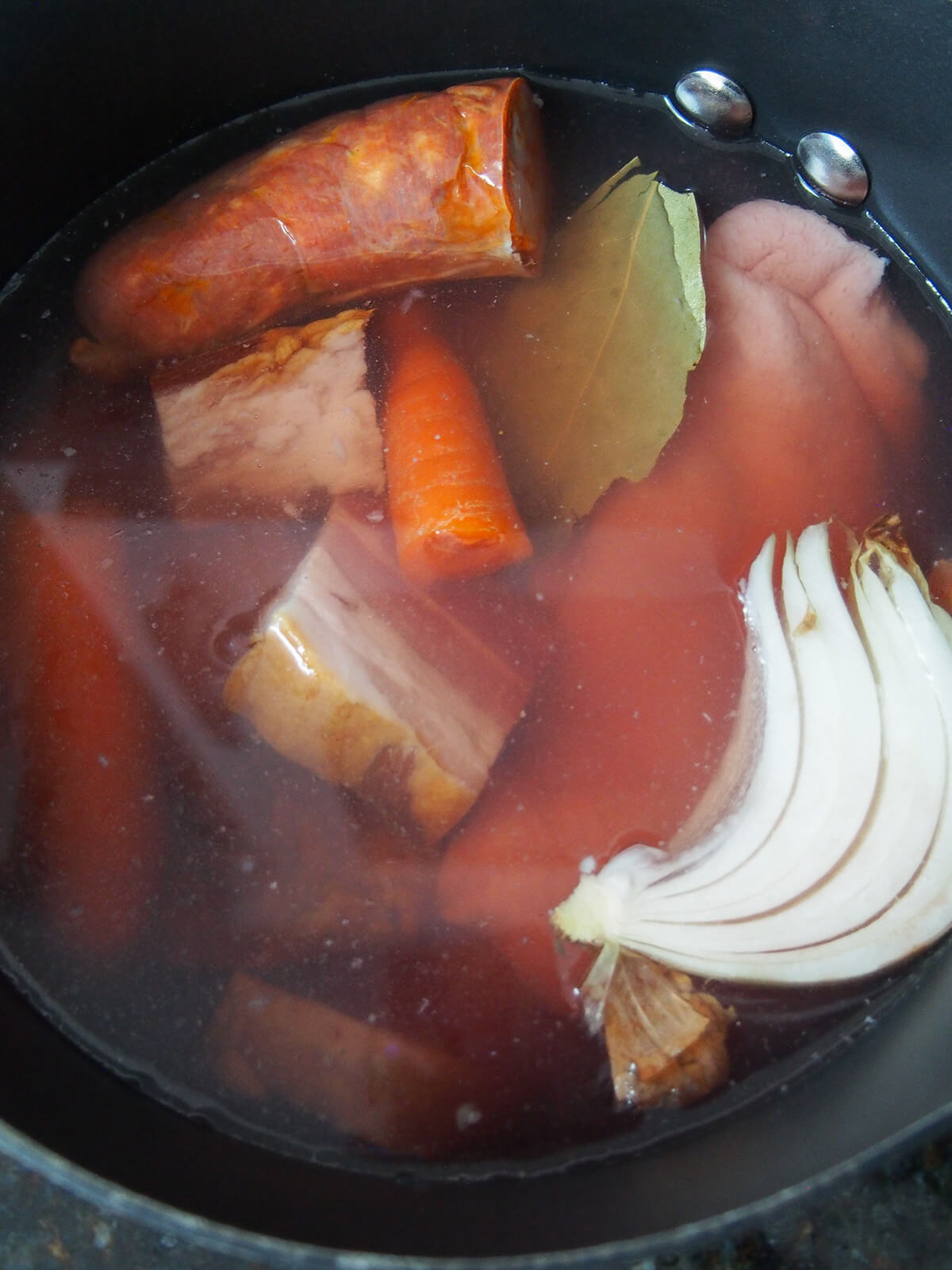 duck, onion, chorico, bacon, carrot, wine and water in pot ready to make stock.
